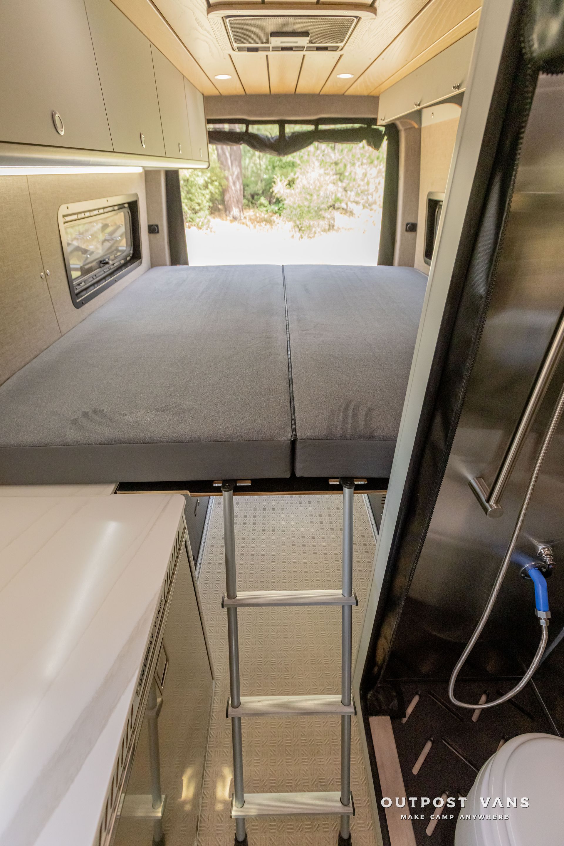 murphy bed and a ladder in the back. Outpost vans Sprinter 170 AWD.