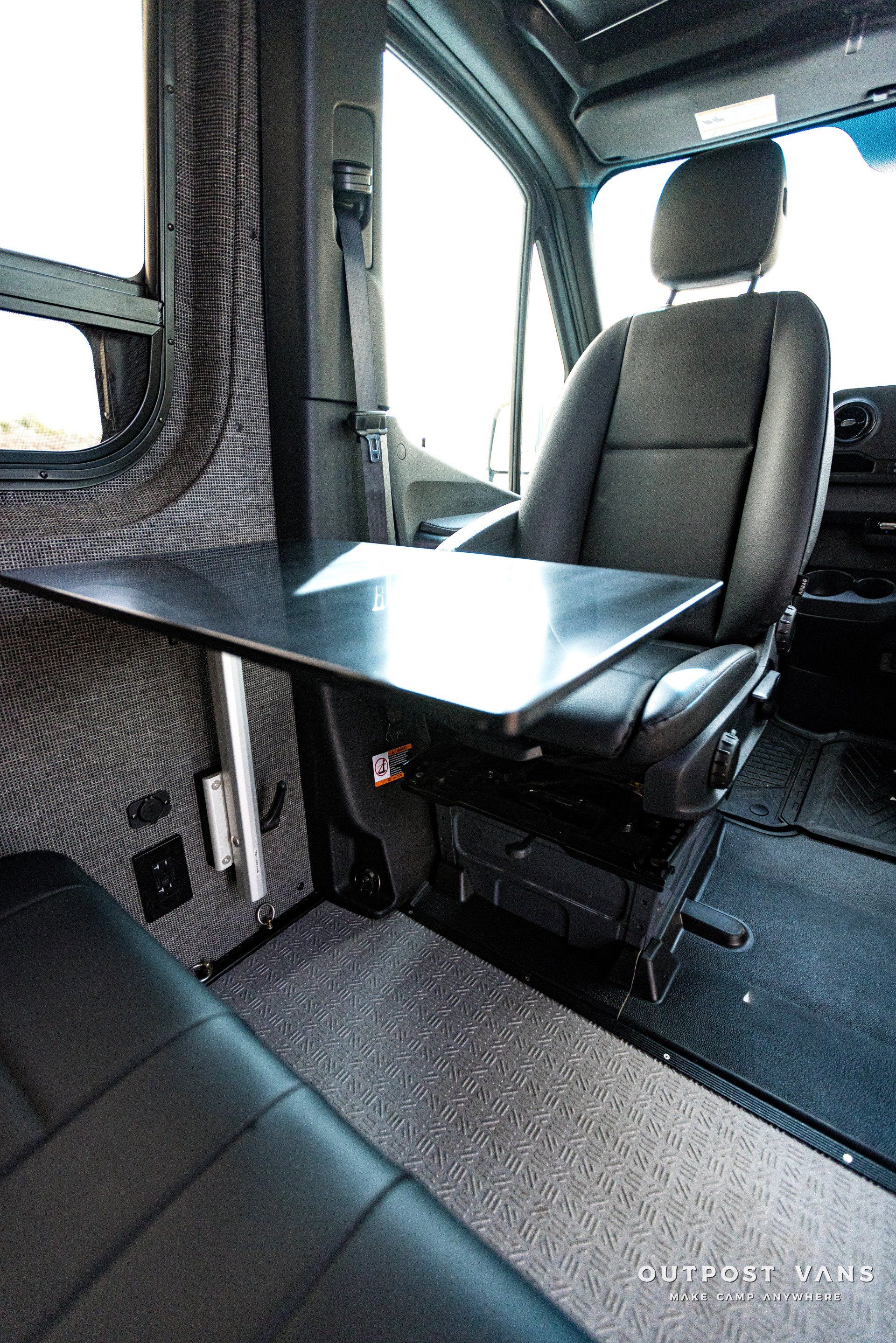 A car with a table in the back seat.