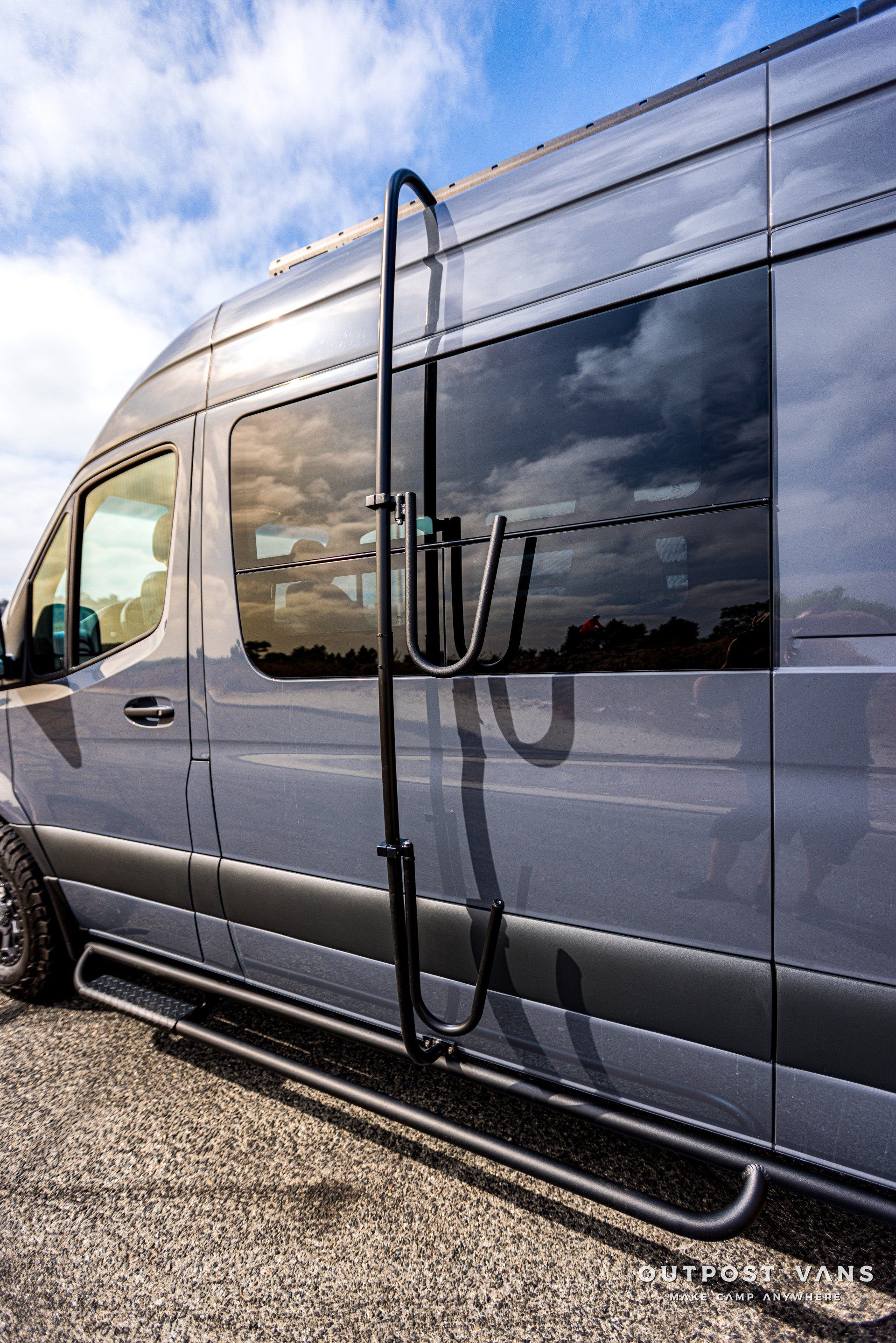 A van with a ladder attached to the side of it.