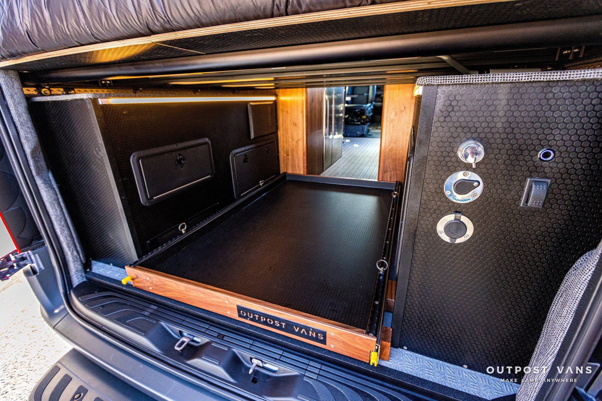 The trunk of a car with a drawer in it