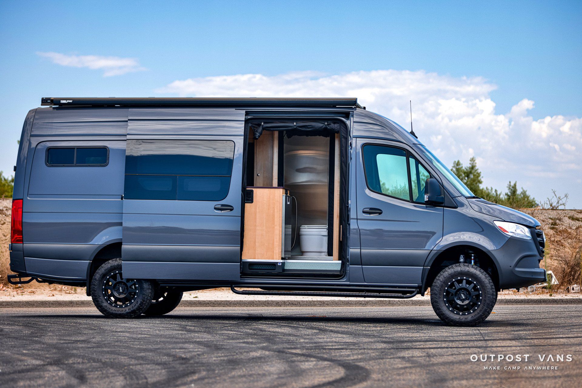 A gray van is parked on the side of the road.