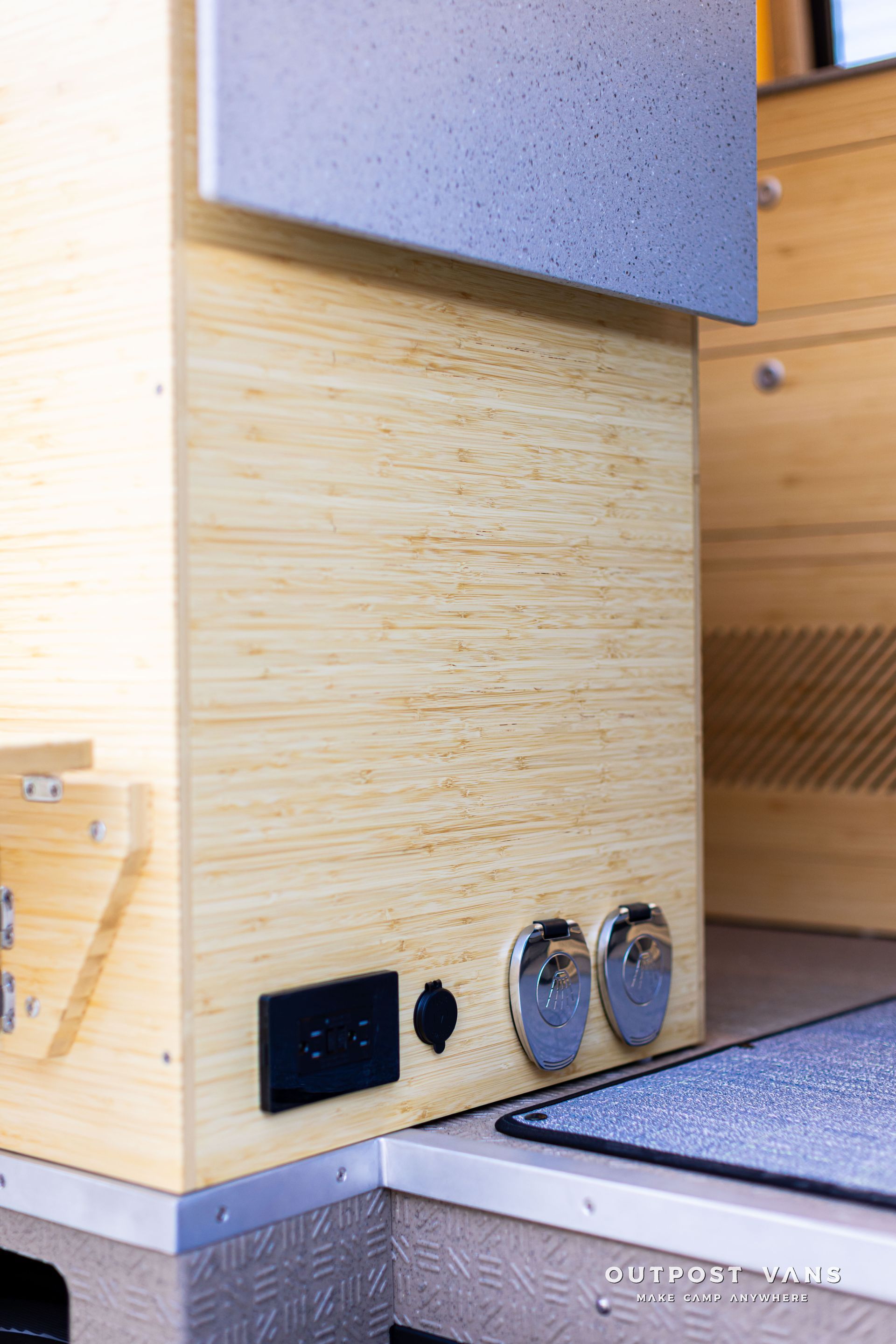 Compact wooden appliance with black and chrome controls beside a gray countertop