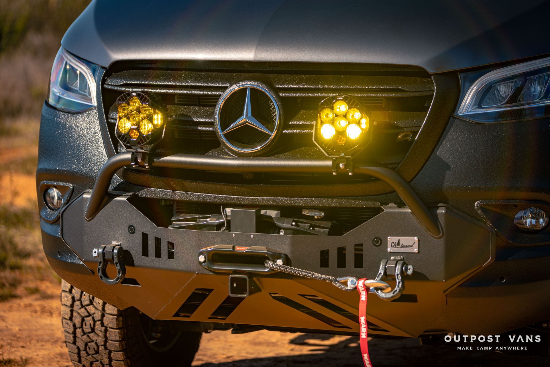 the front bumper of a mercedes sprinter van with a winch attached to it .