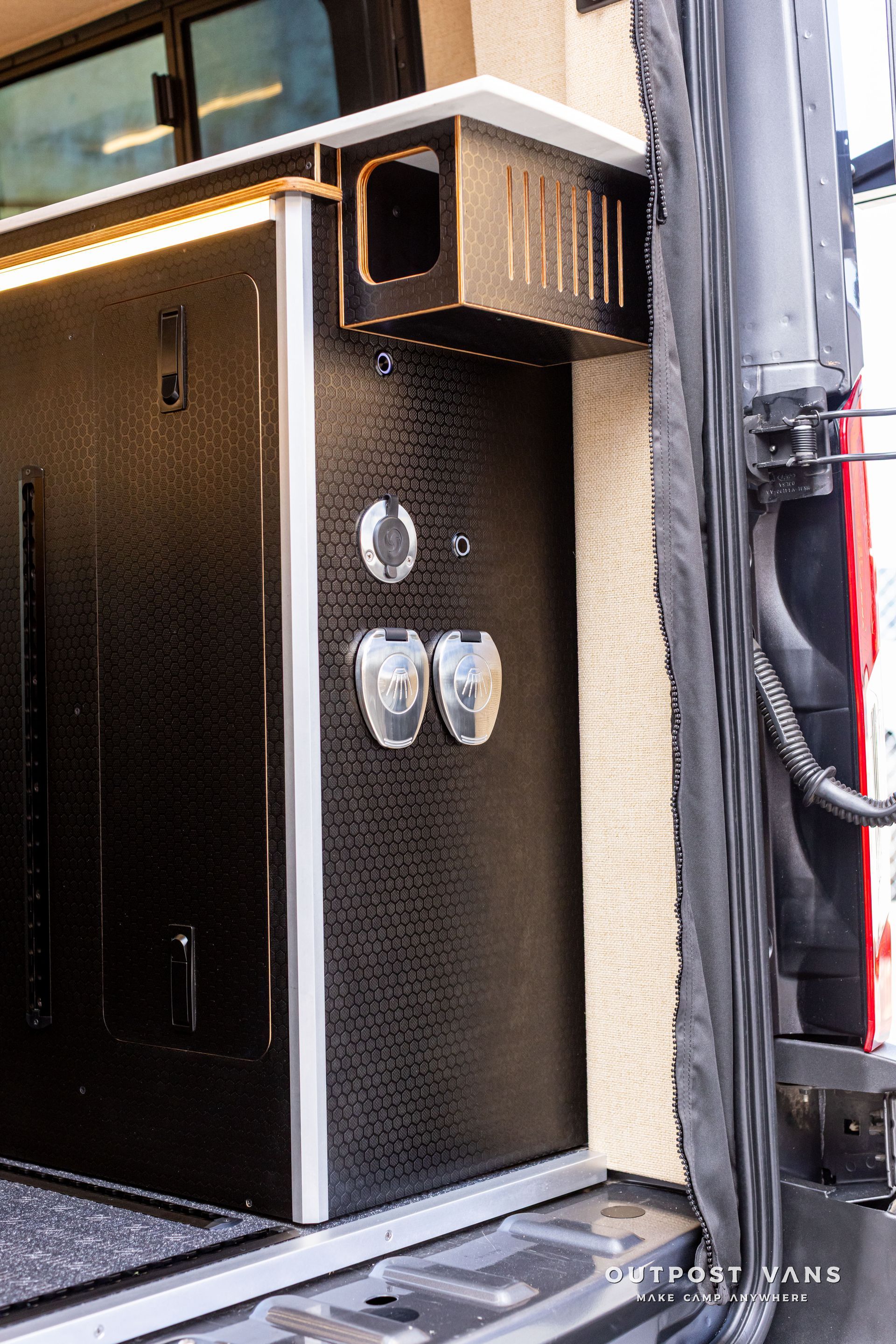 Black textured cabinet with chrome latches and trim inside a truck or trailer bed