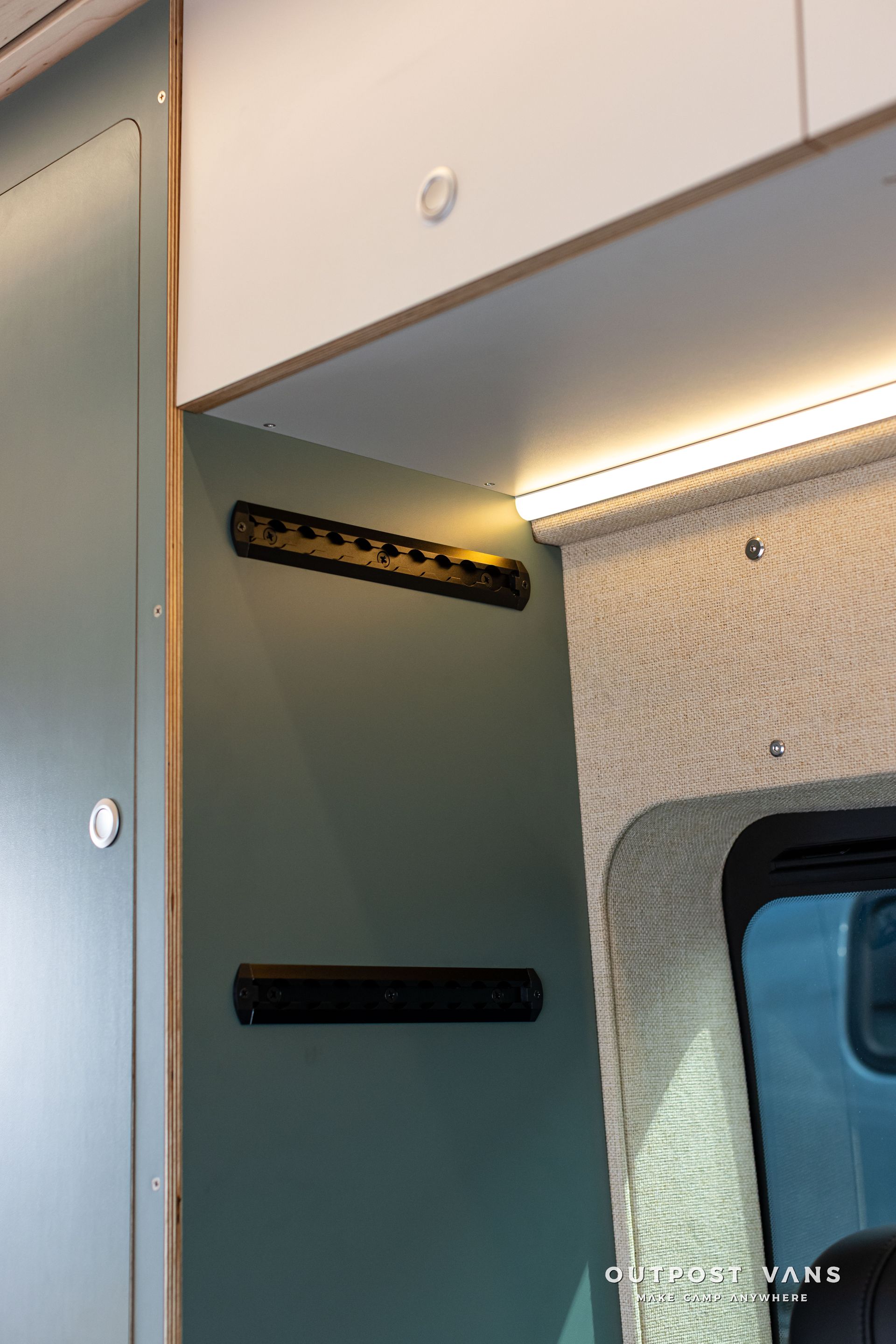 Interior of a vehicle cabinet with open shelves and a window on the right
