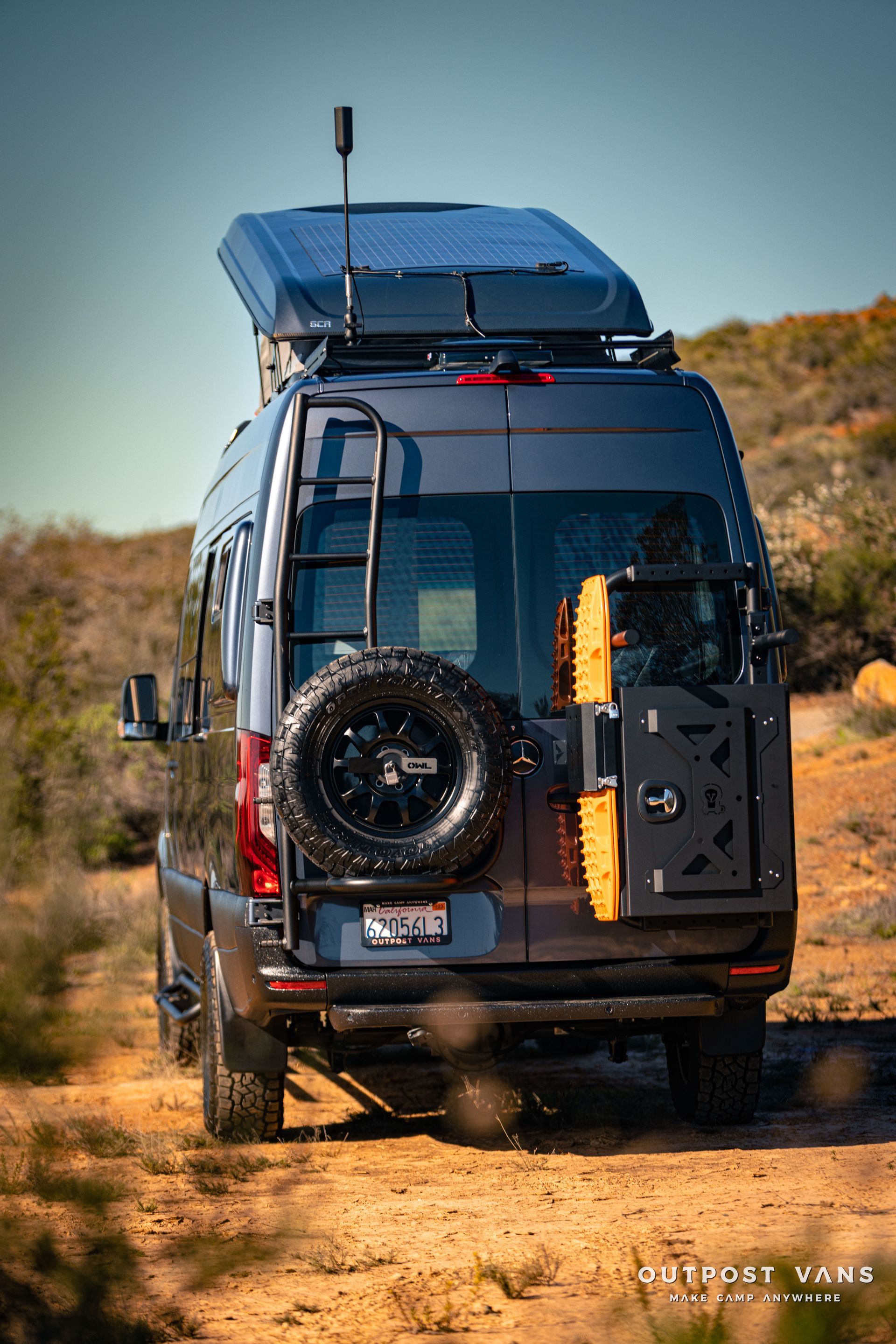 a van is parked on the side of a dirt road .