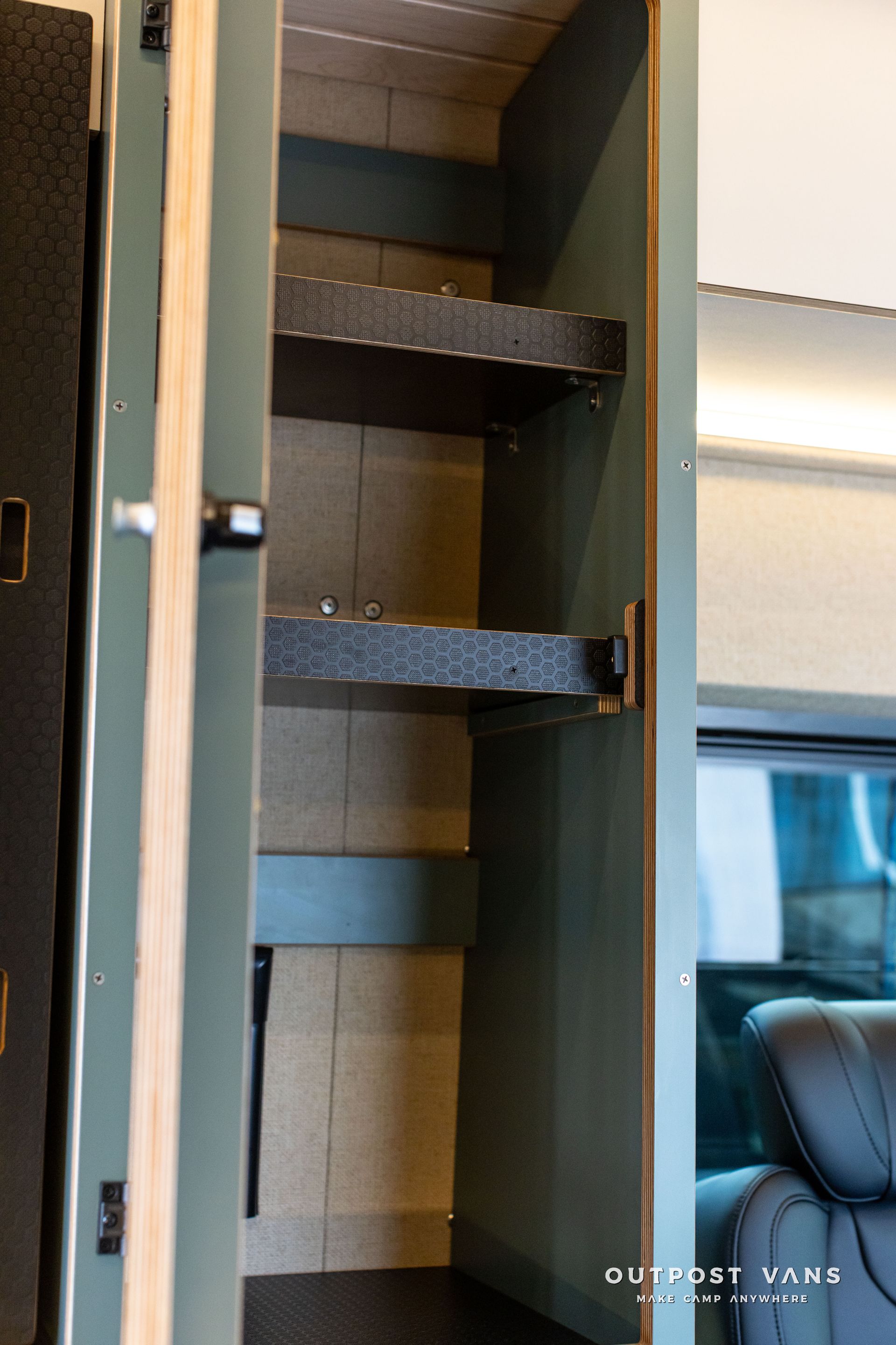 Open cabinet with three dark shelves and a light interior.