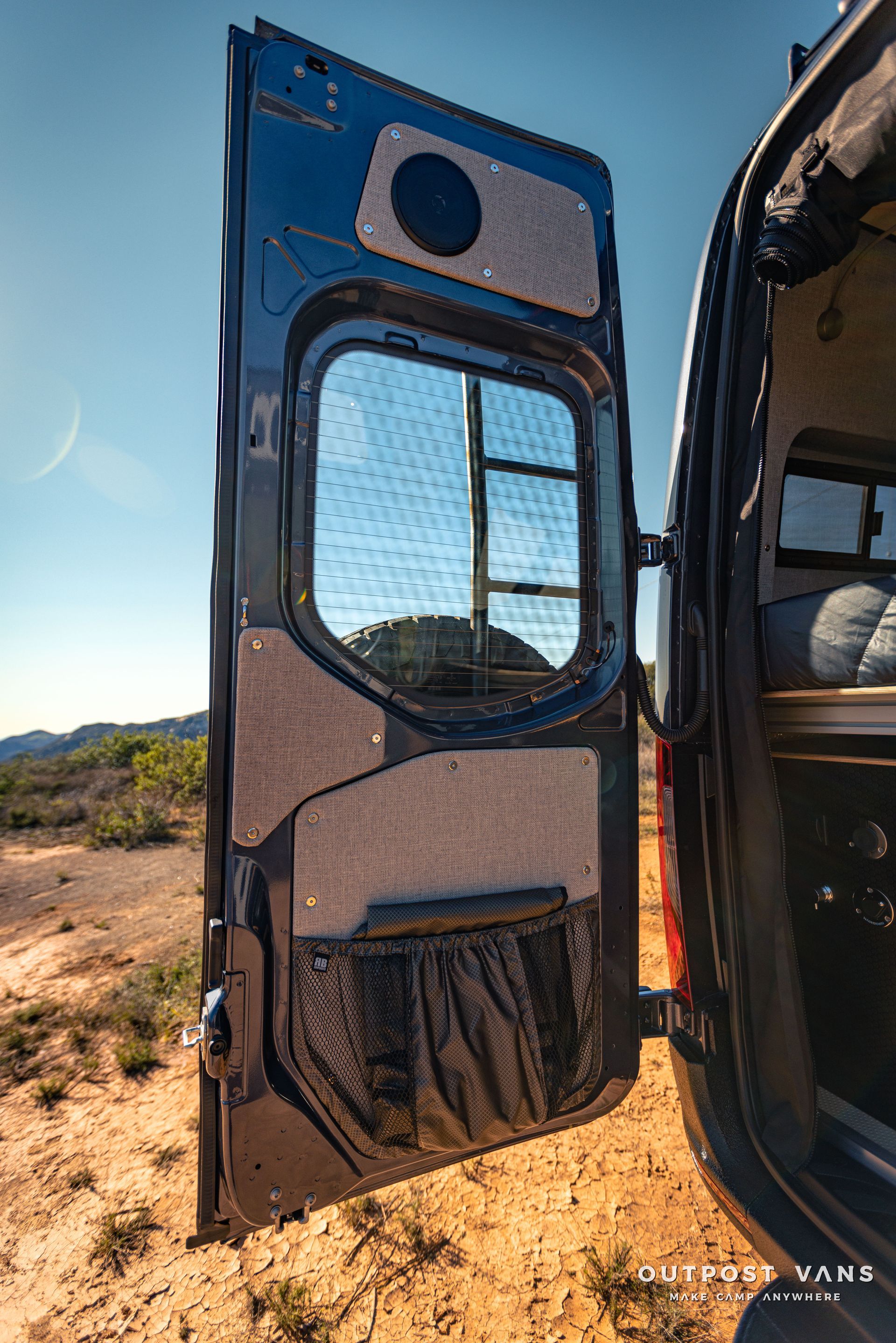 the door of a van is open in the desert .
