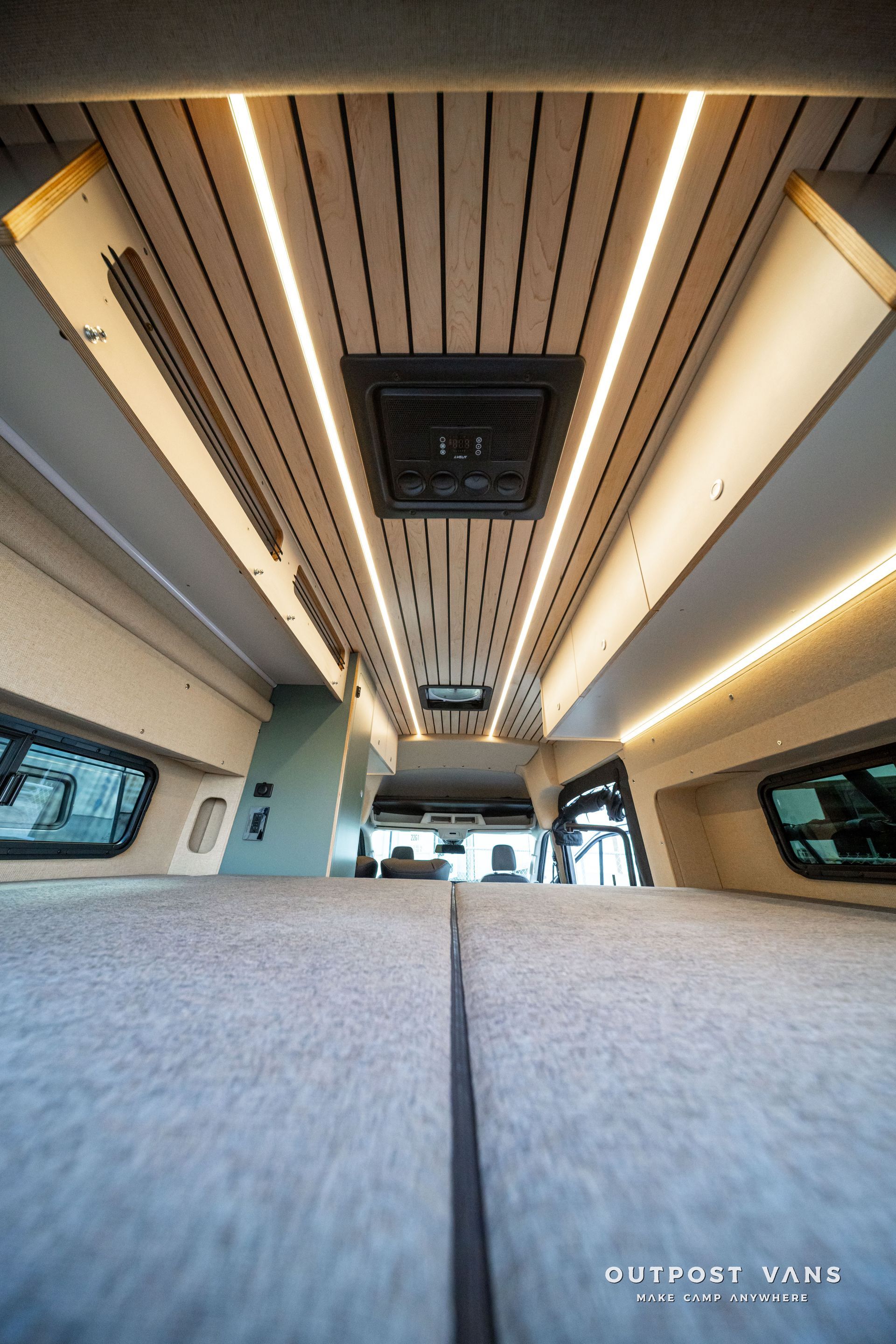 Modern train interior with wide aisle, gray seats, and warm ceiling lights