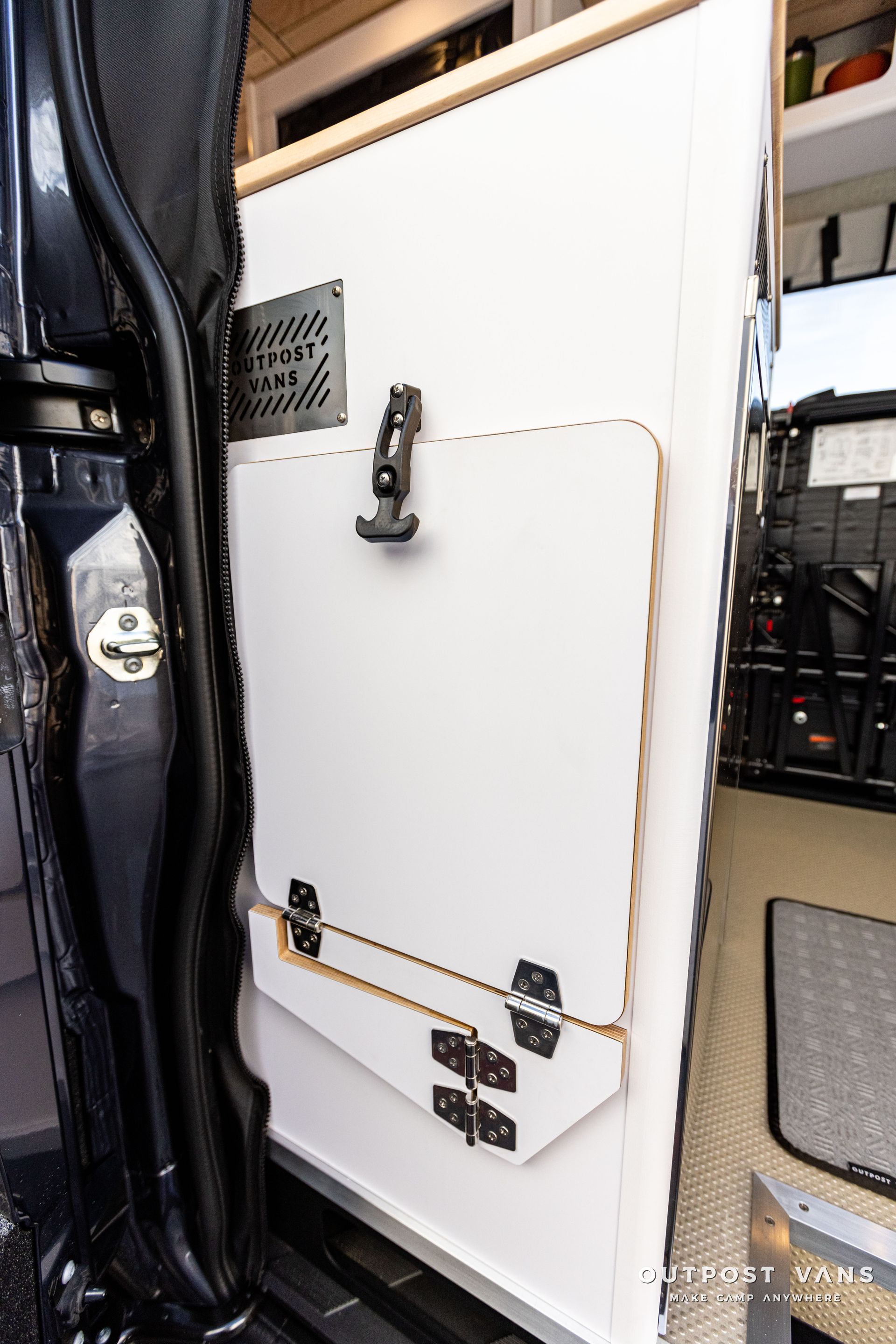 a white door with a lock on it is open in a van .