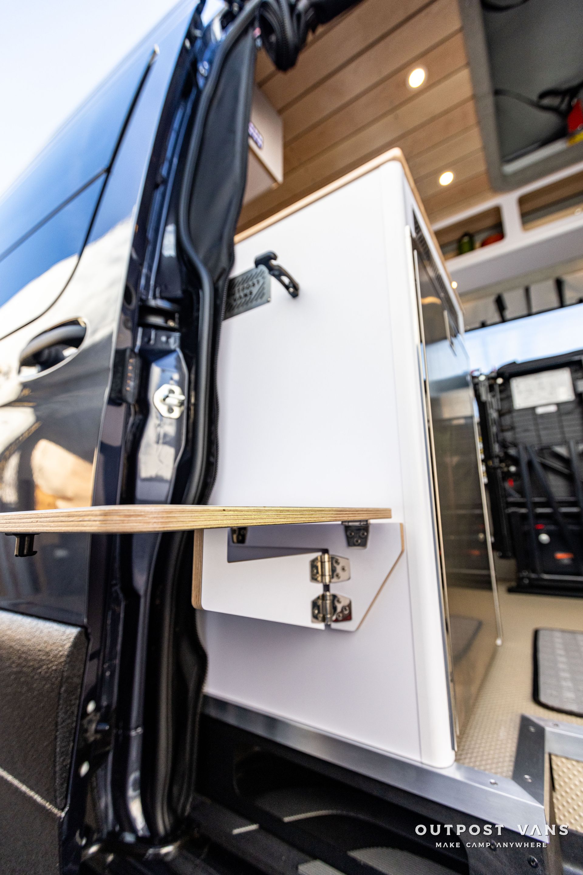a van with a wooden table attached to the side of it .