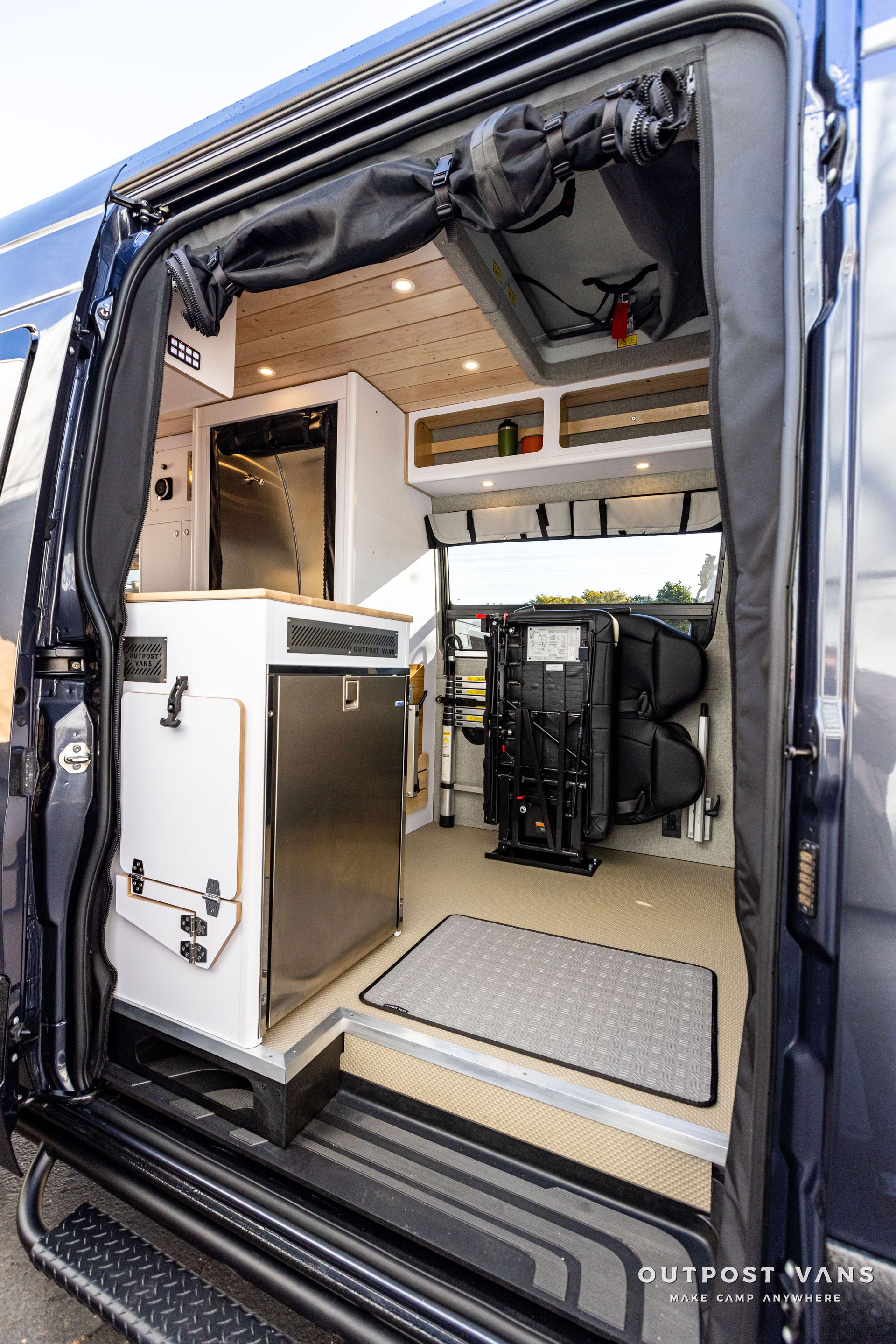 the inside of a camper van with the door open .