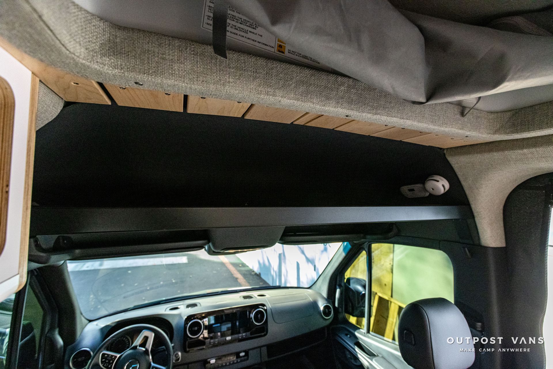 the inside of a van with a shelf on the ceiling .