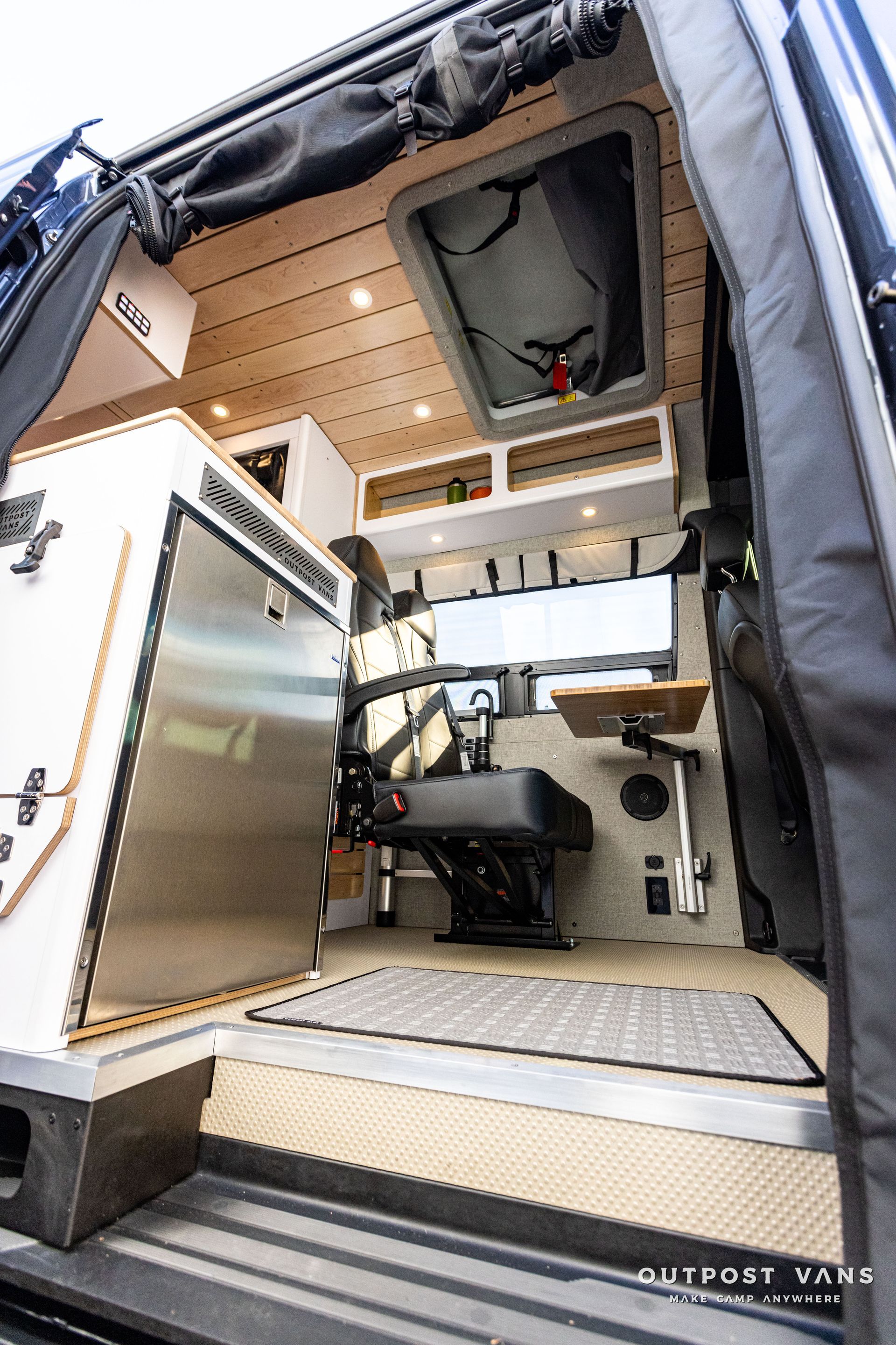 the inside of a van with the door open and a ceiling fan .