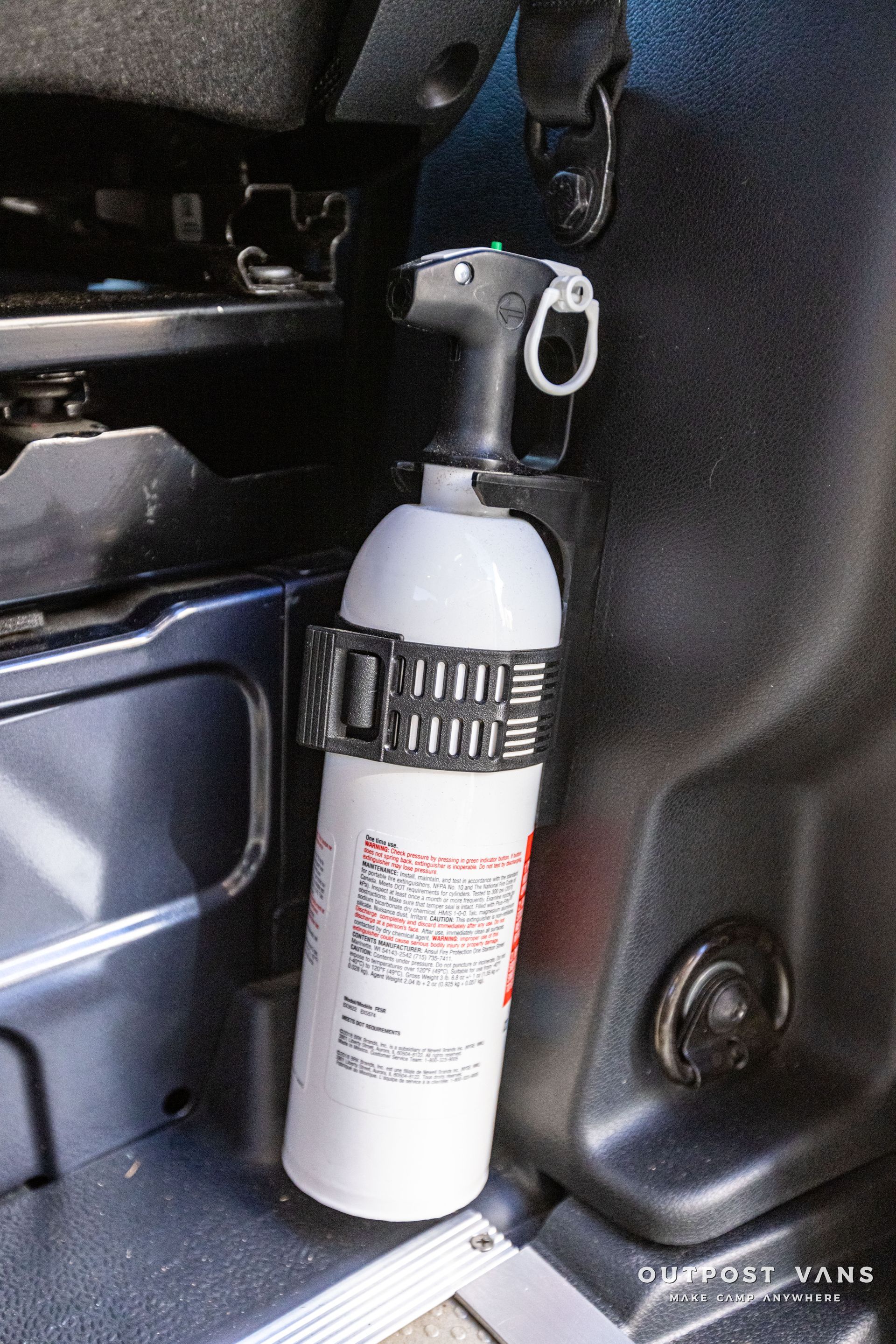 a spray bottle is sitting in the back of a car .