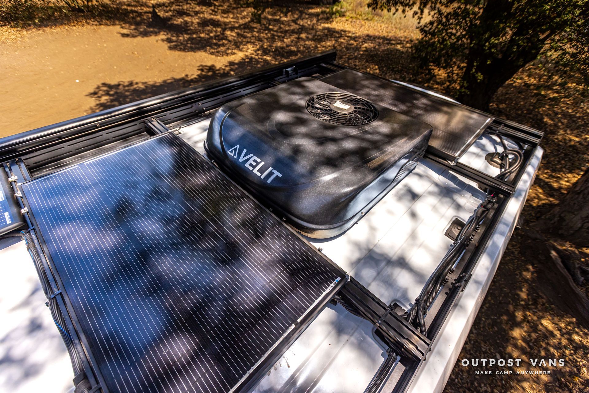 Roof rack with a black rooftop tent on a vehicle in an outdoor setting