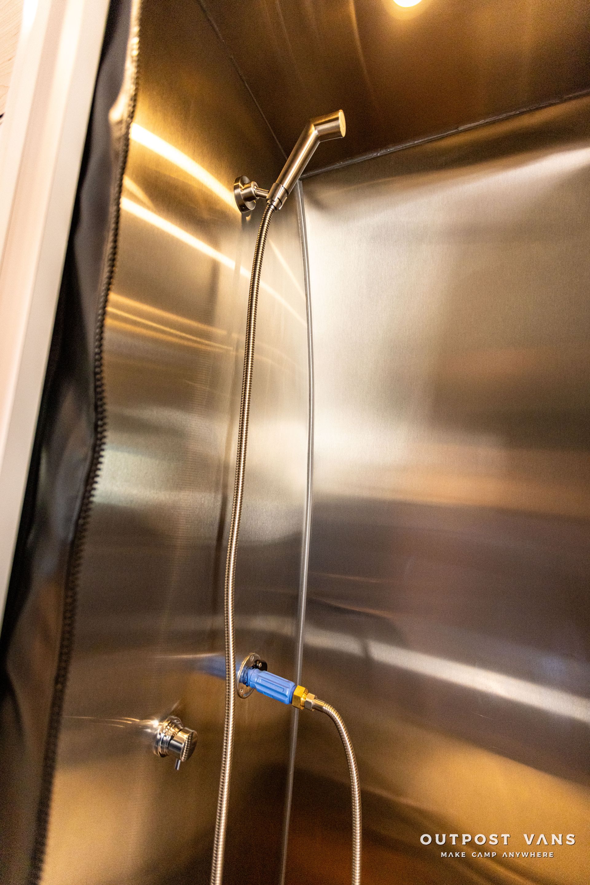 a close up of a shower head with water coming out of it