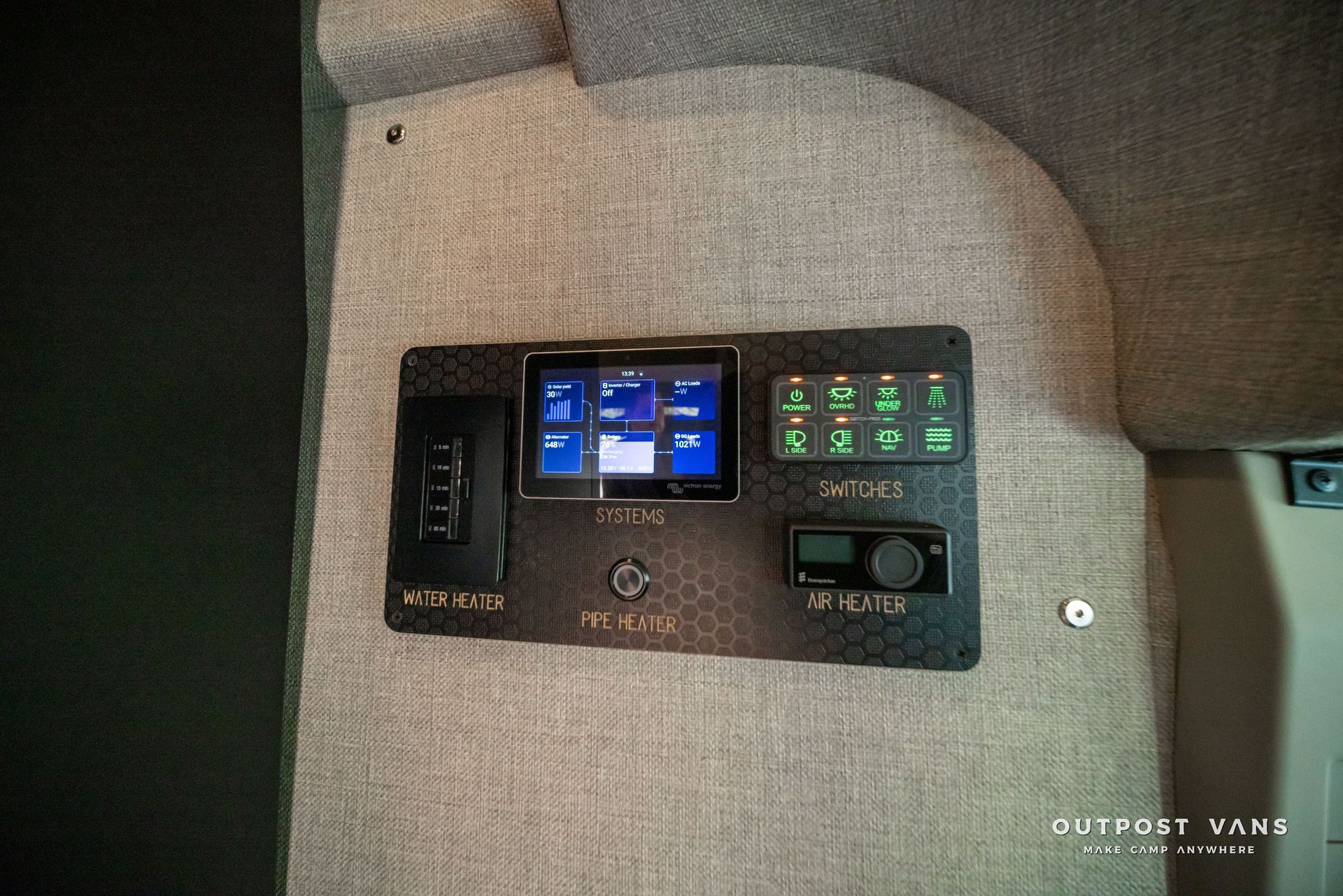 Boat control panel with blue and green digital displays mounted in a gray interior compartment