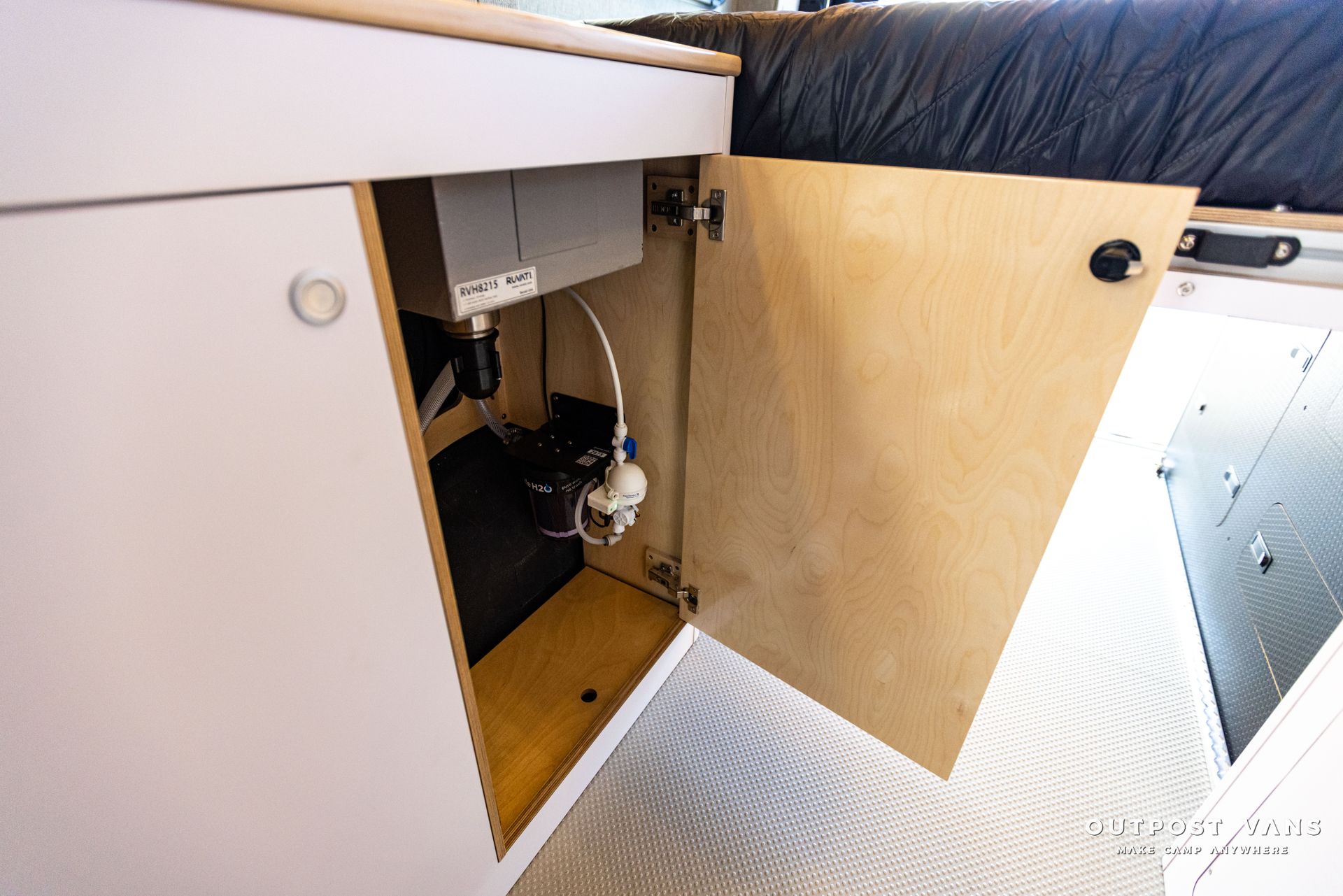 a cabinet with the door open and a cord coming out of it .