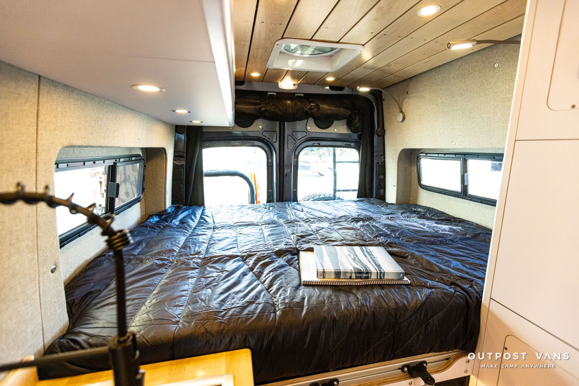 there is a bed in the back of a van .