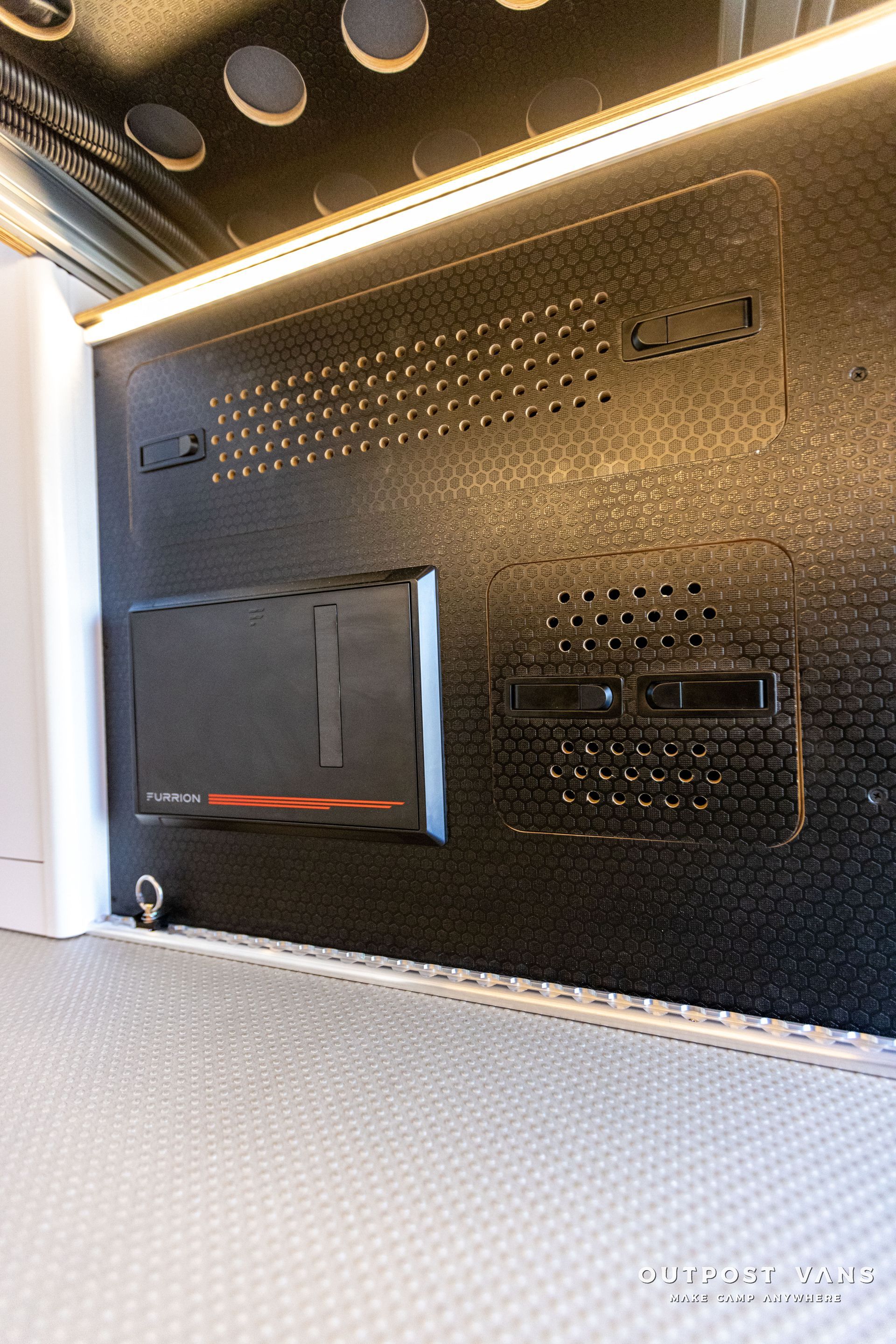 a close up of a black wall with a speaker on it .