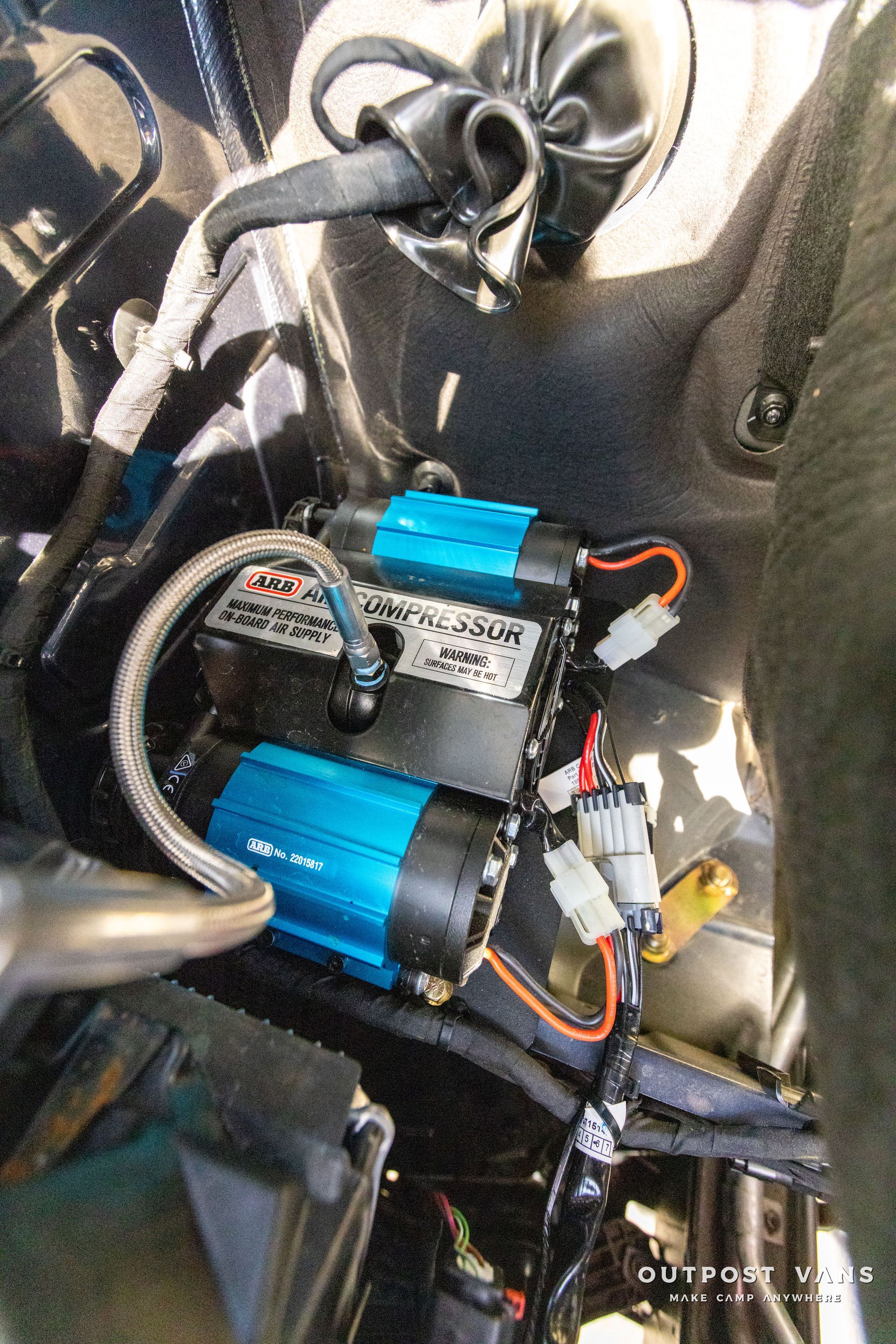 a couple of air compressors are sitting inside of a car .