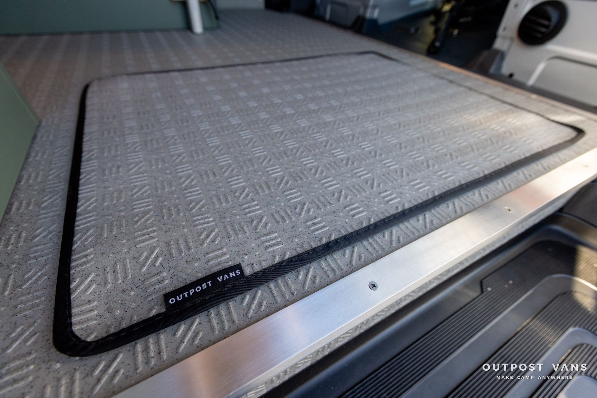 a gray mat is sitting on top of a metal surface .