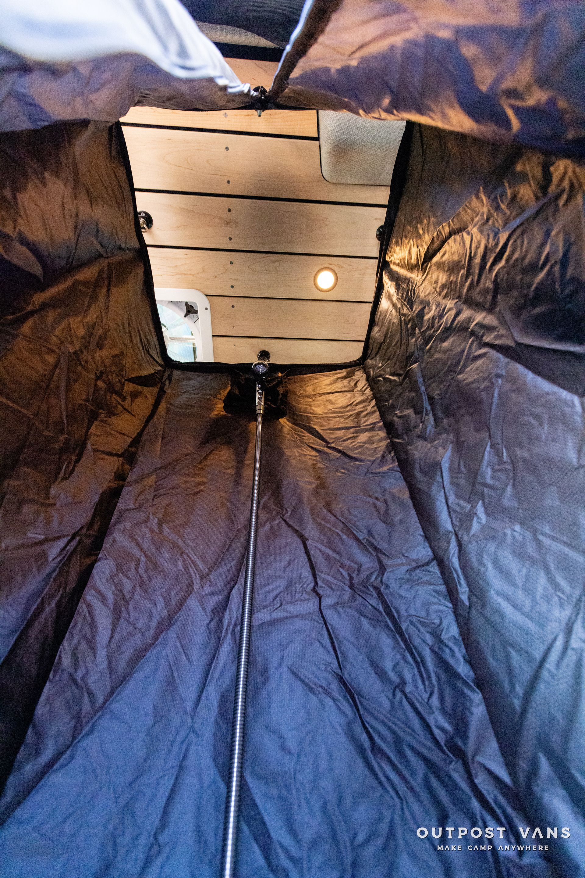 the inside of a tent with a wooden ceiling .