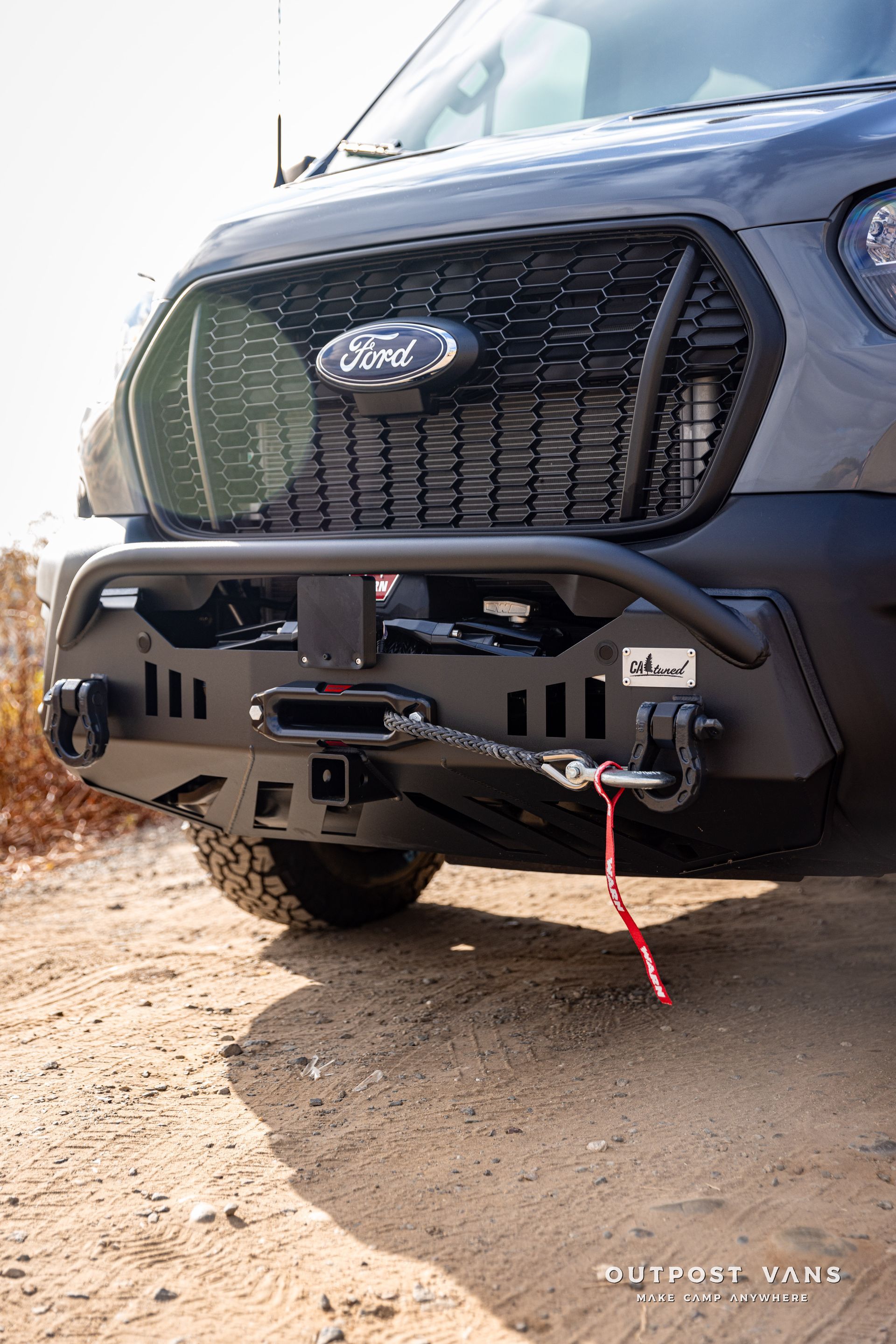 the front bumper of a ford transit with a winch attached to it .
