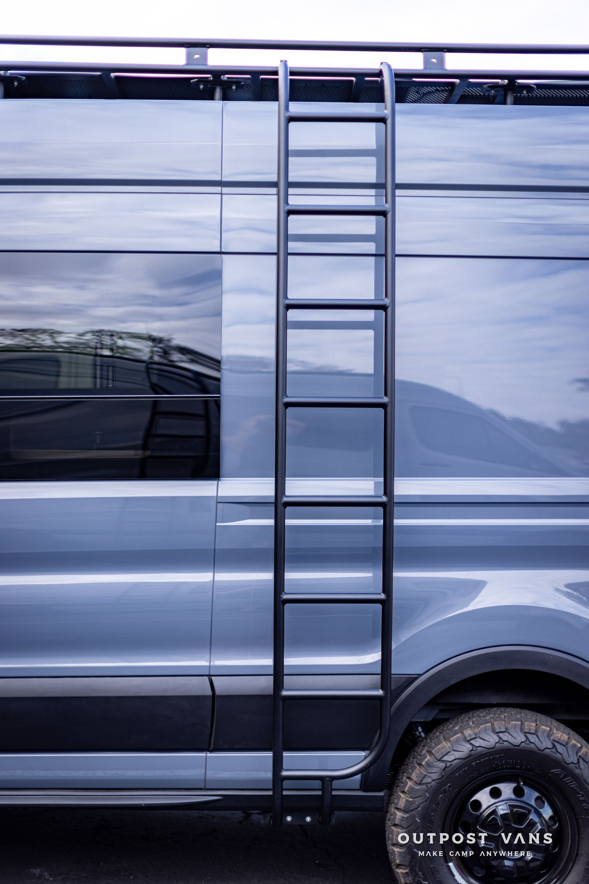 a van with a ladder attached to the side of it .