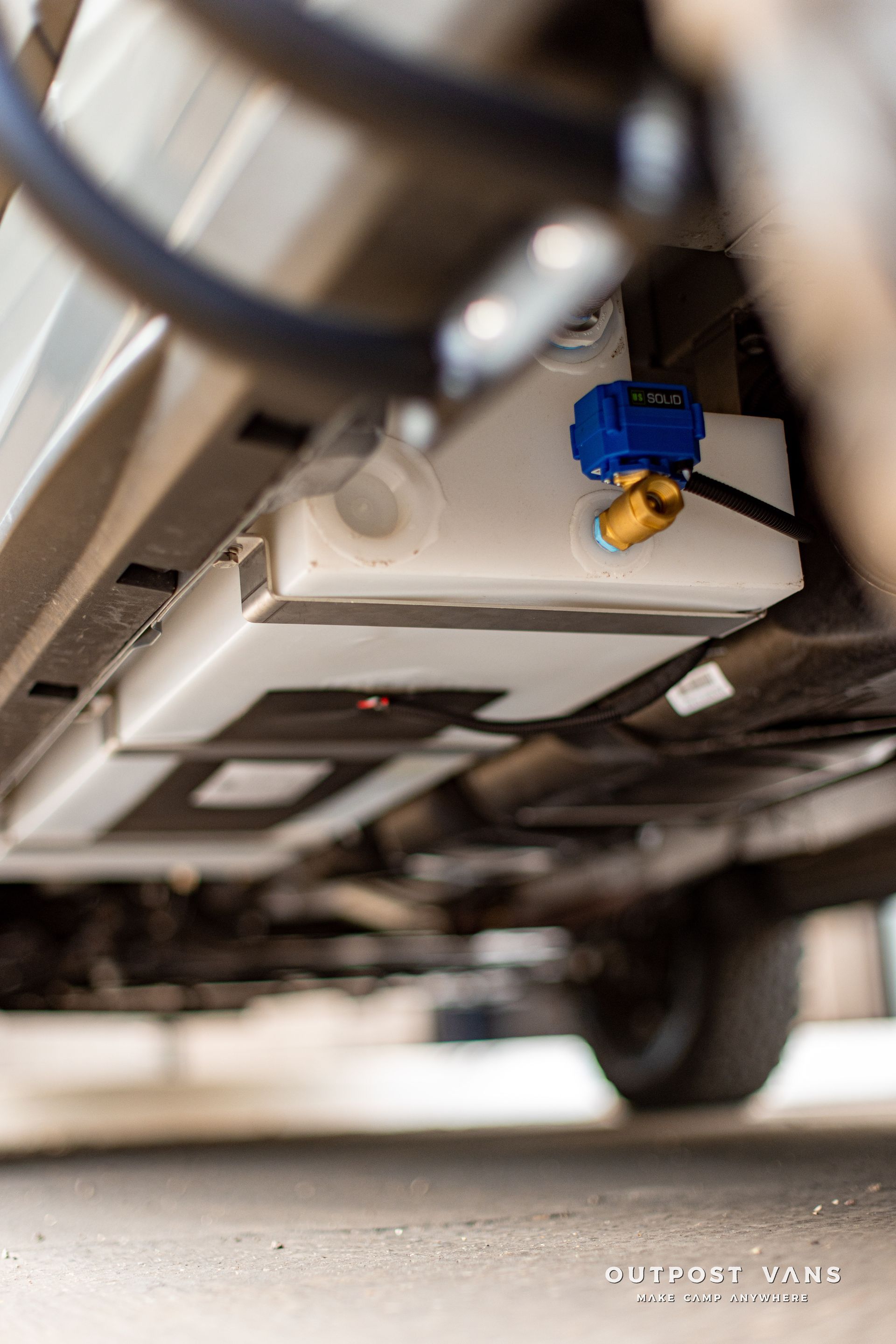 a close up of a fuel tank under a car .