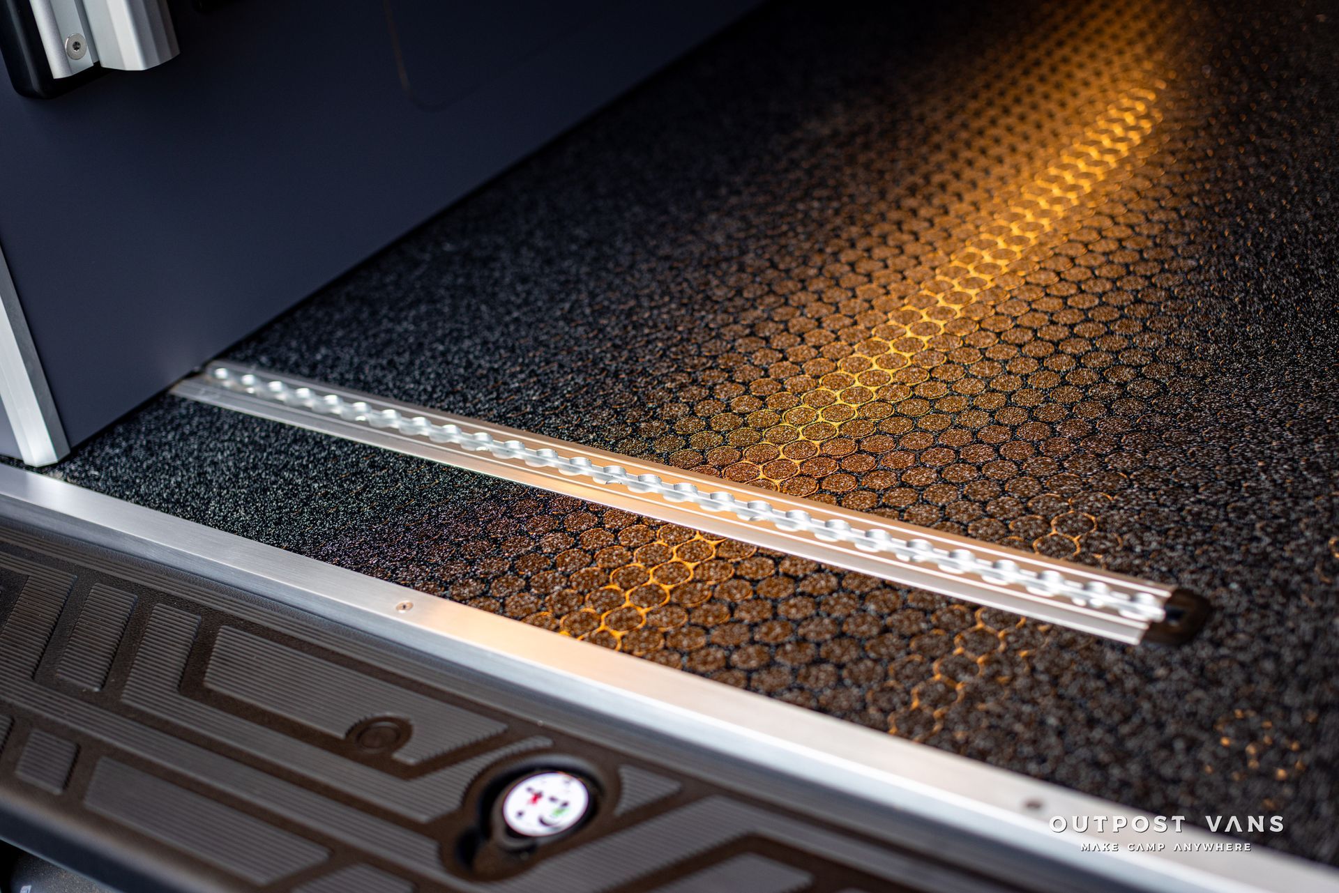 a close up of a metal railing on the floor of a vehicle .