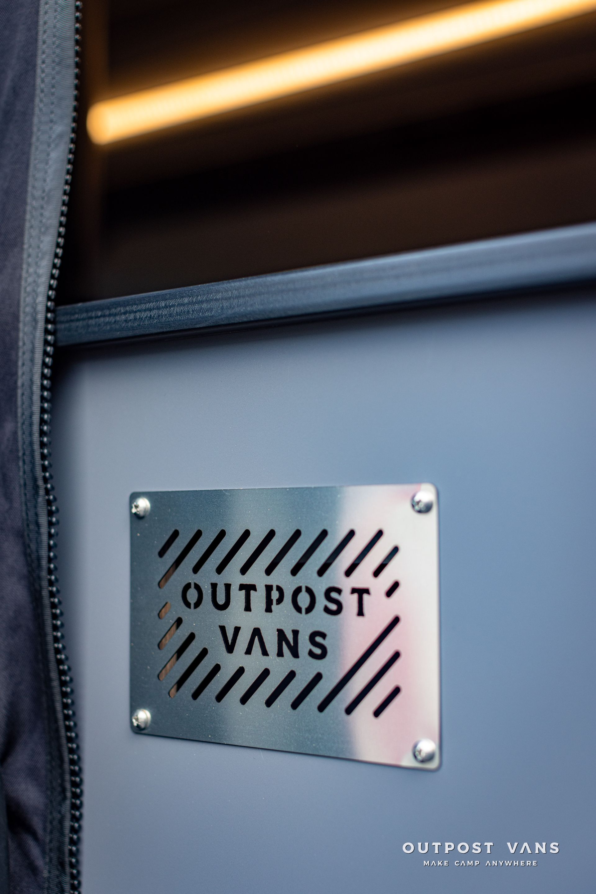 a metal sign that says outpost vans on it
