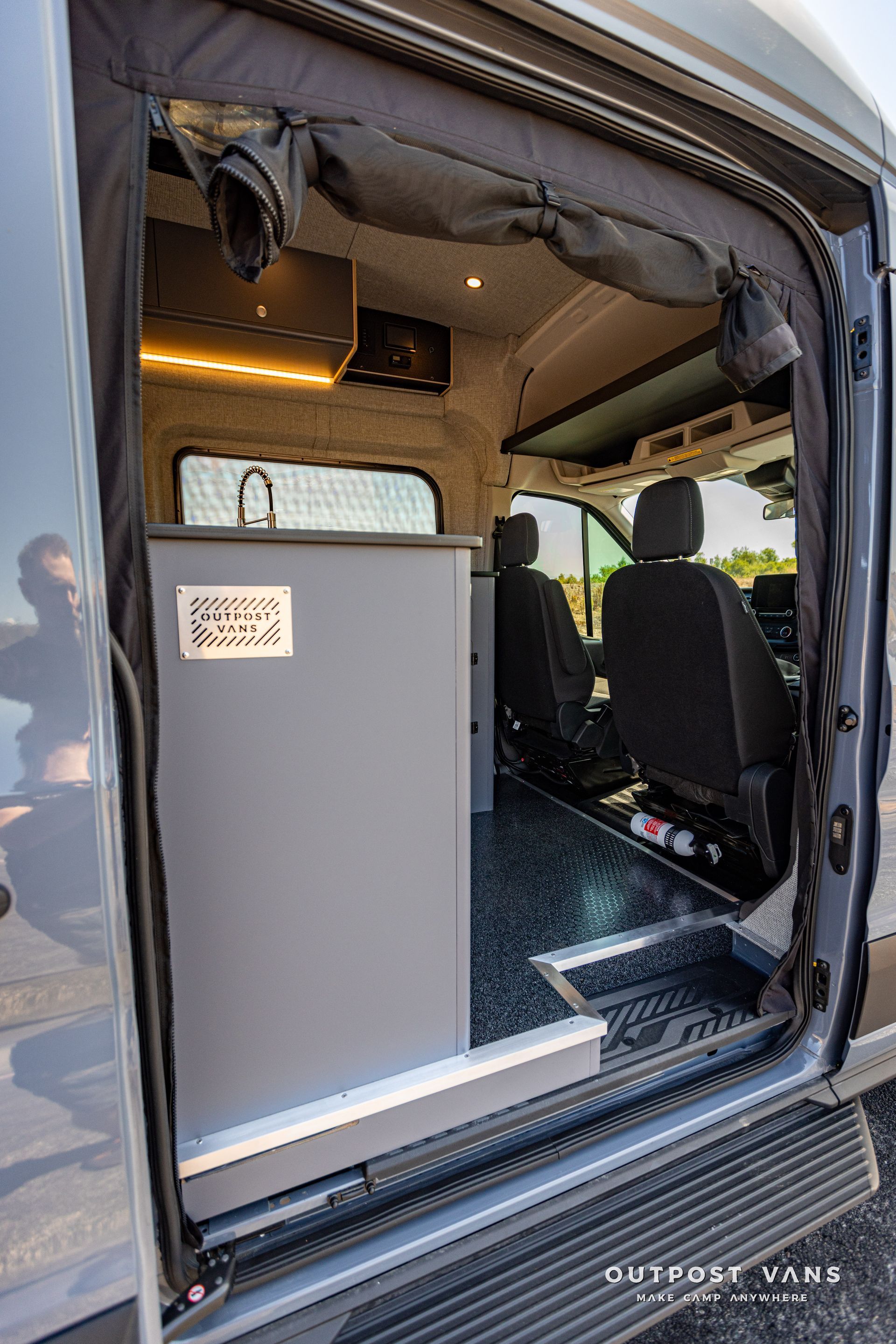 the door of a van is open and shows the inside of the van .
