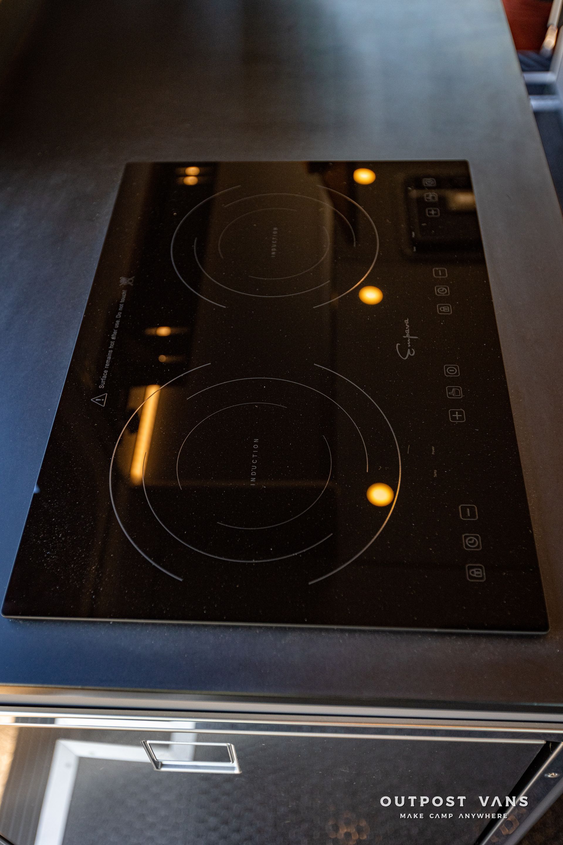 a black stove top oven is sitting on top of a black counter .