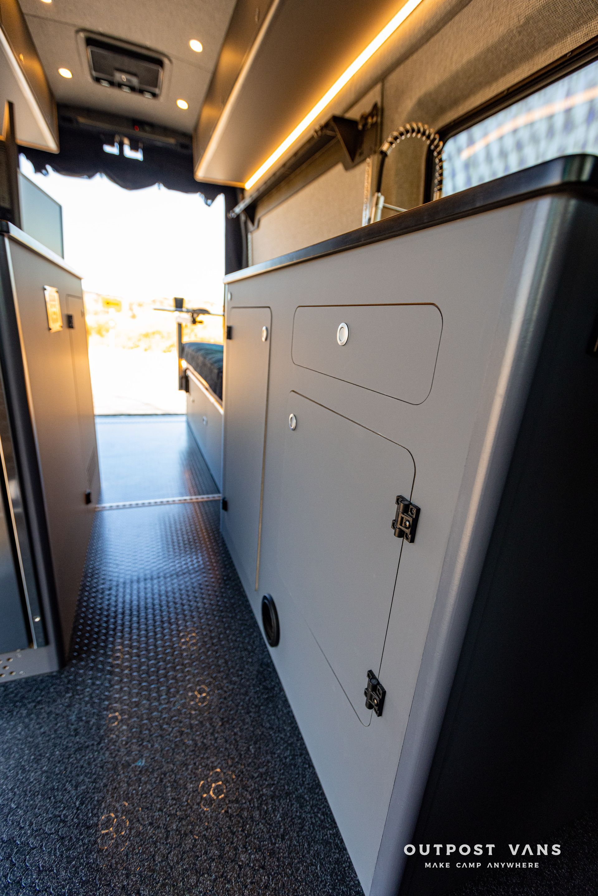 the inside of a camper van with a lot of cabinets and drawers .