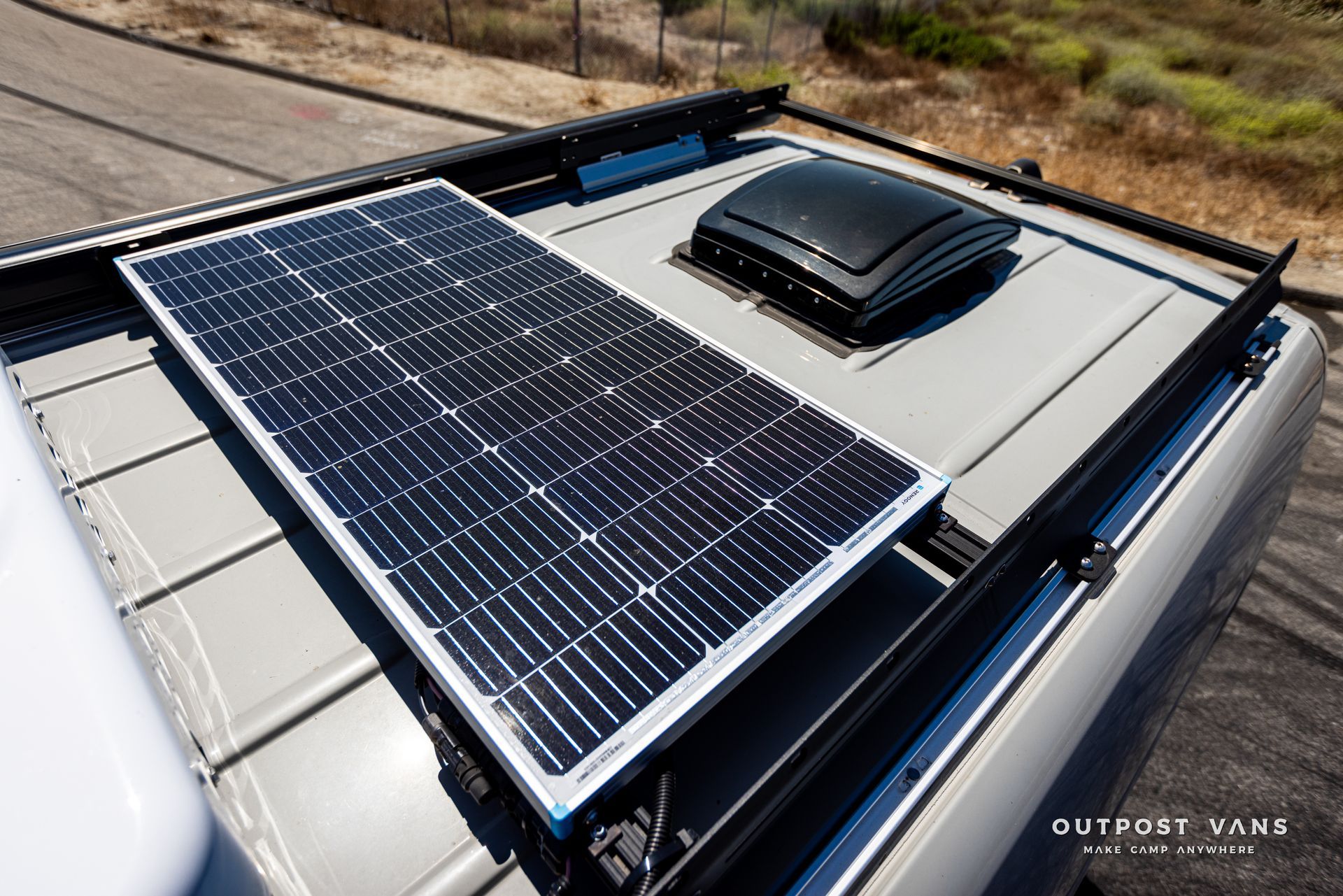 A solar panel is mounted to the roof of a van