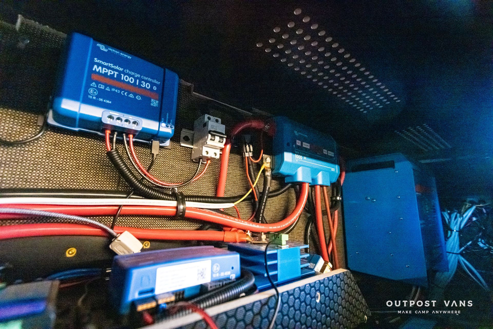 A bunch of wires are connected to a blue box.