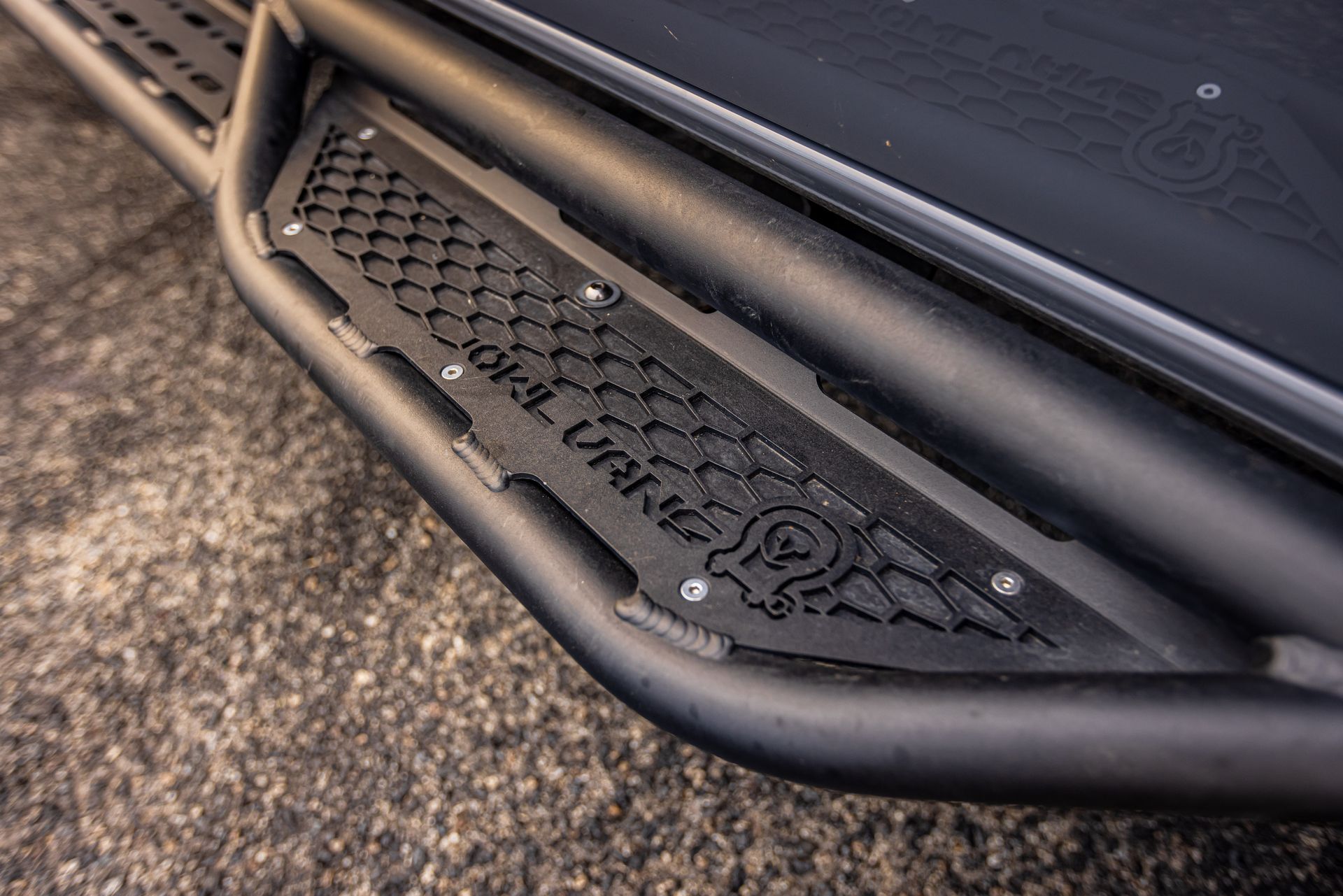 A close up of a black side step on a truck.