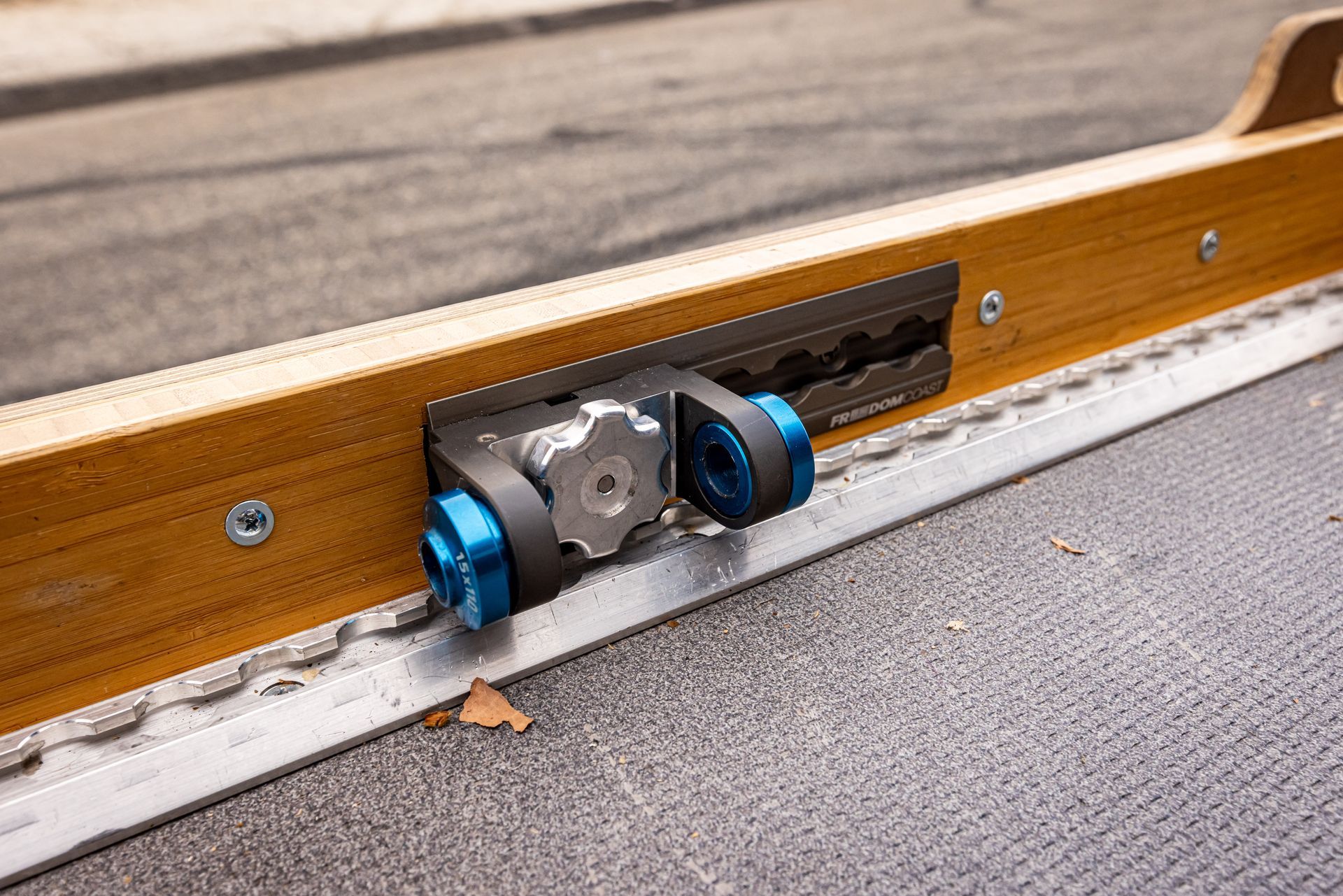 A close up of a wooden railing with a metal railing attached to it.