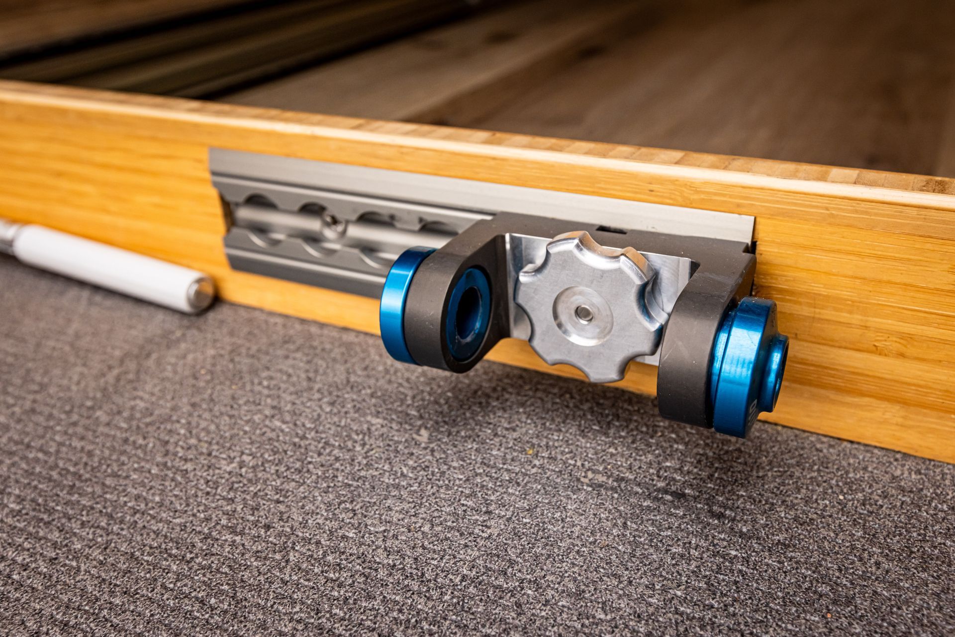 A close up of a metal object on a wooden surface.