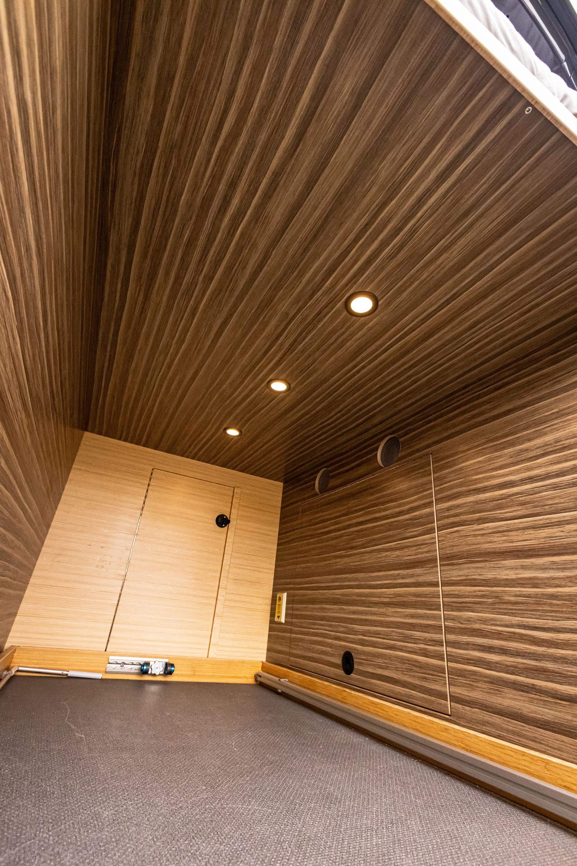 A room with a wooden ceiling and a wooden wall.