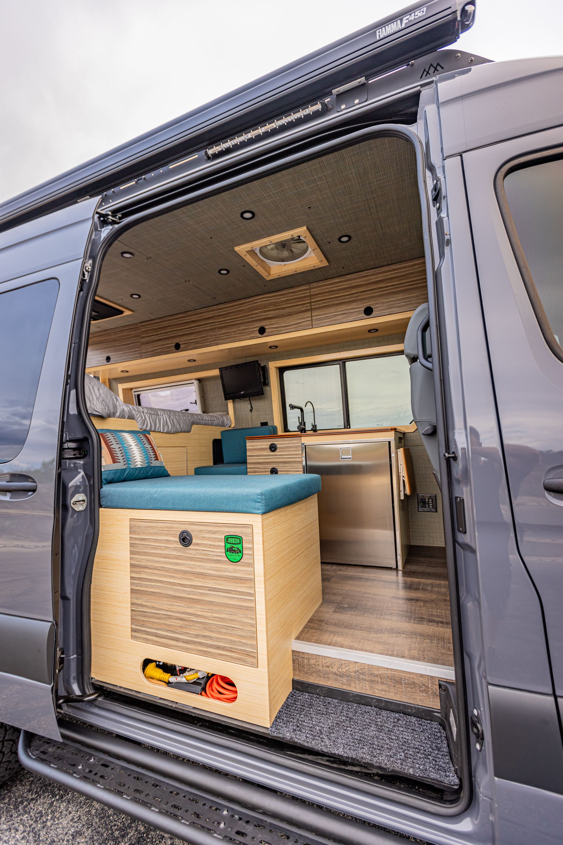 The inside of a camper van with the door open.