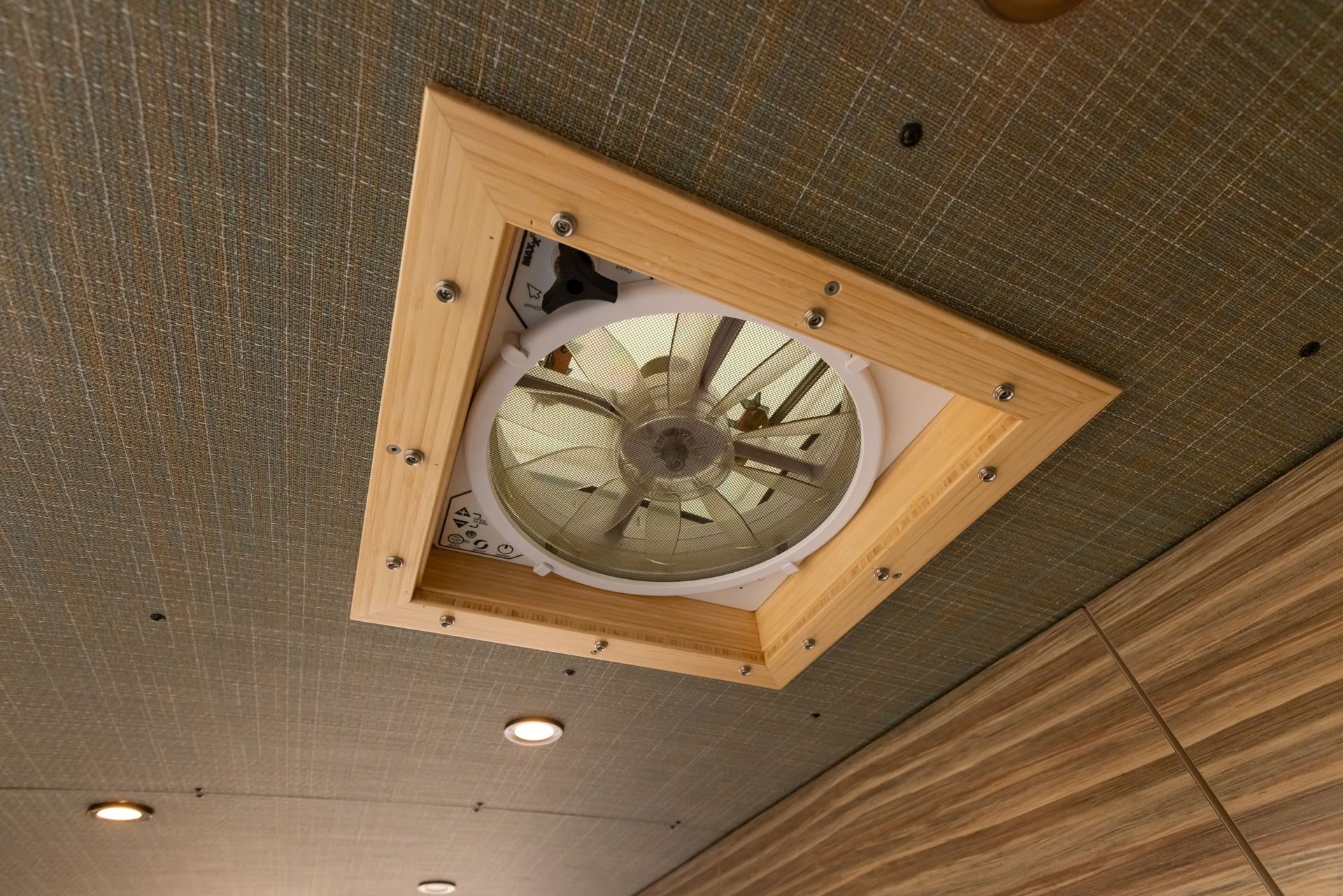 A fan is hanging from the ceiling of a room.