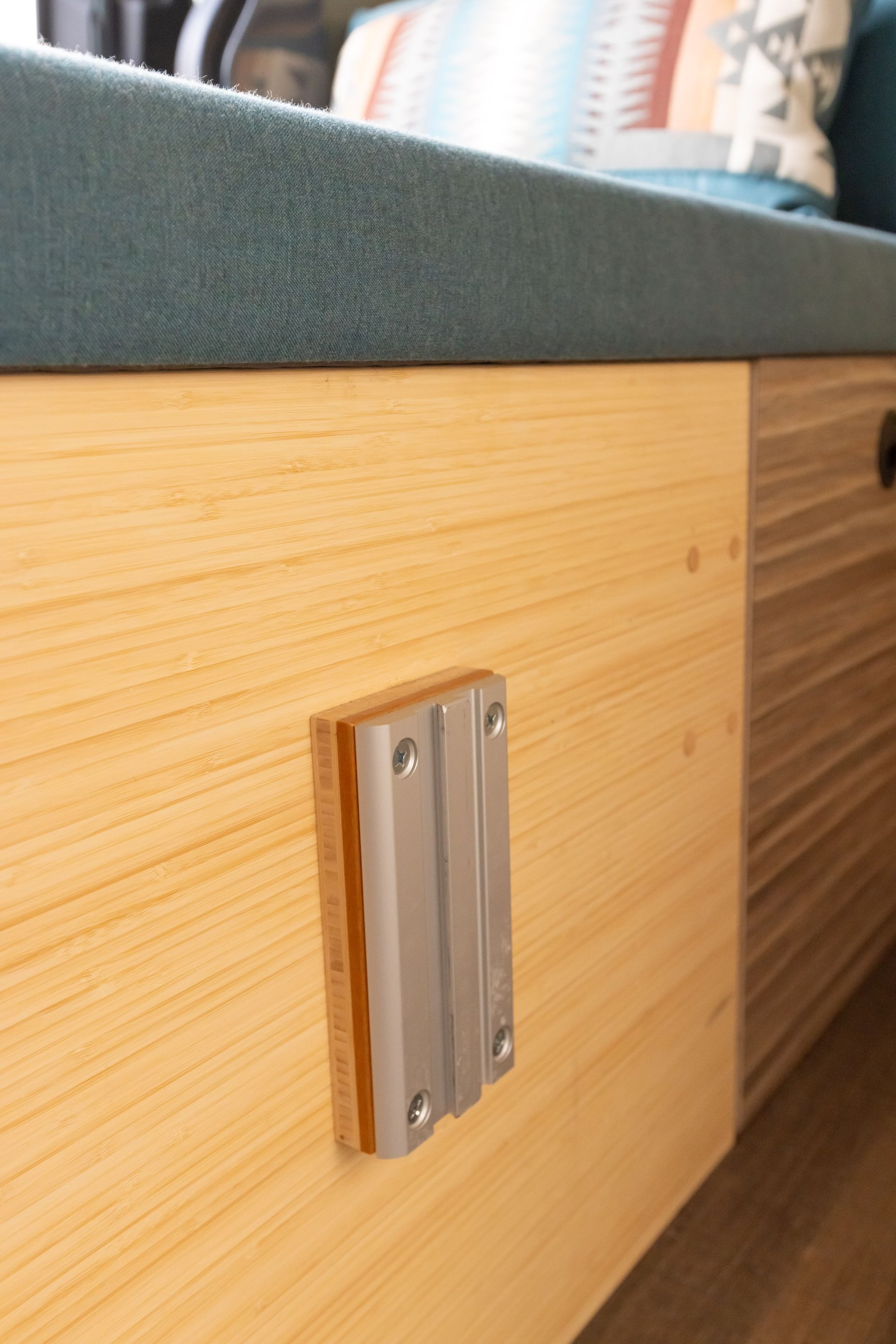 A close up of a wooden cabinet with a metal bracket on it.