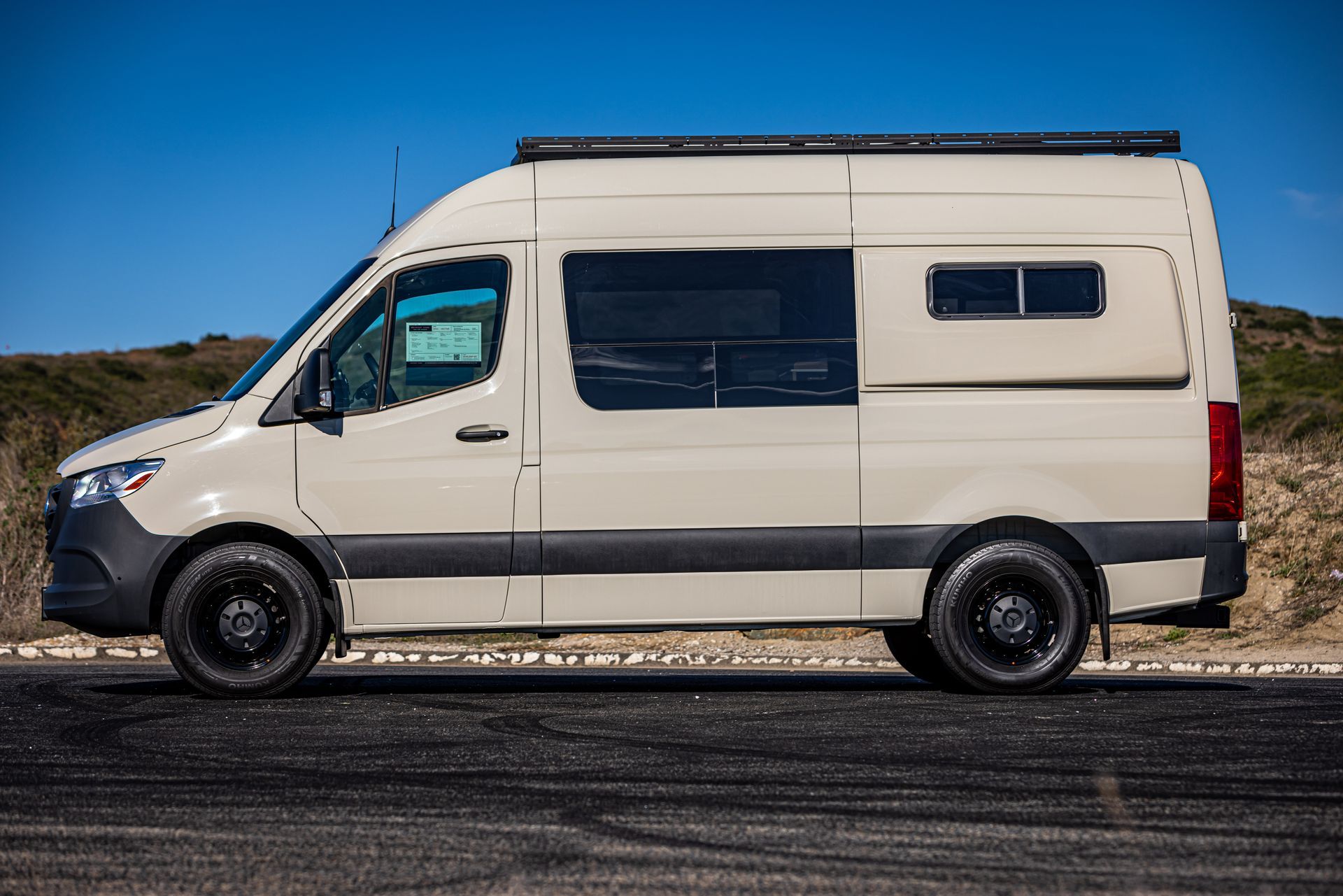 A white van is parked on the side of the road.