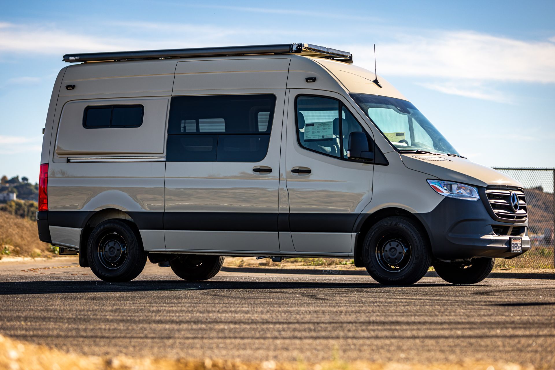 A white van is parked on the side of the road.