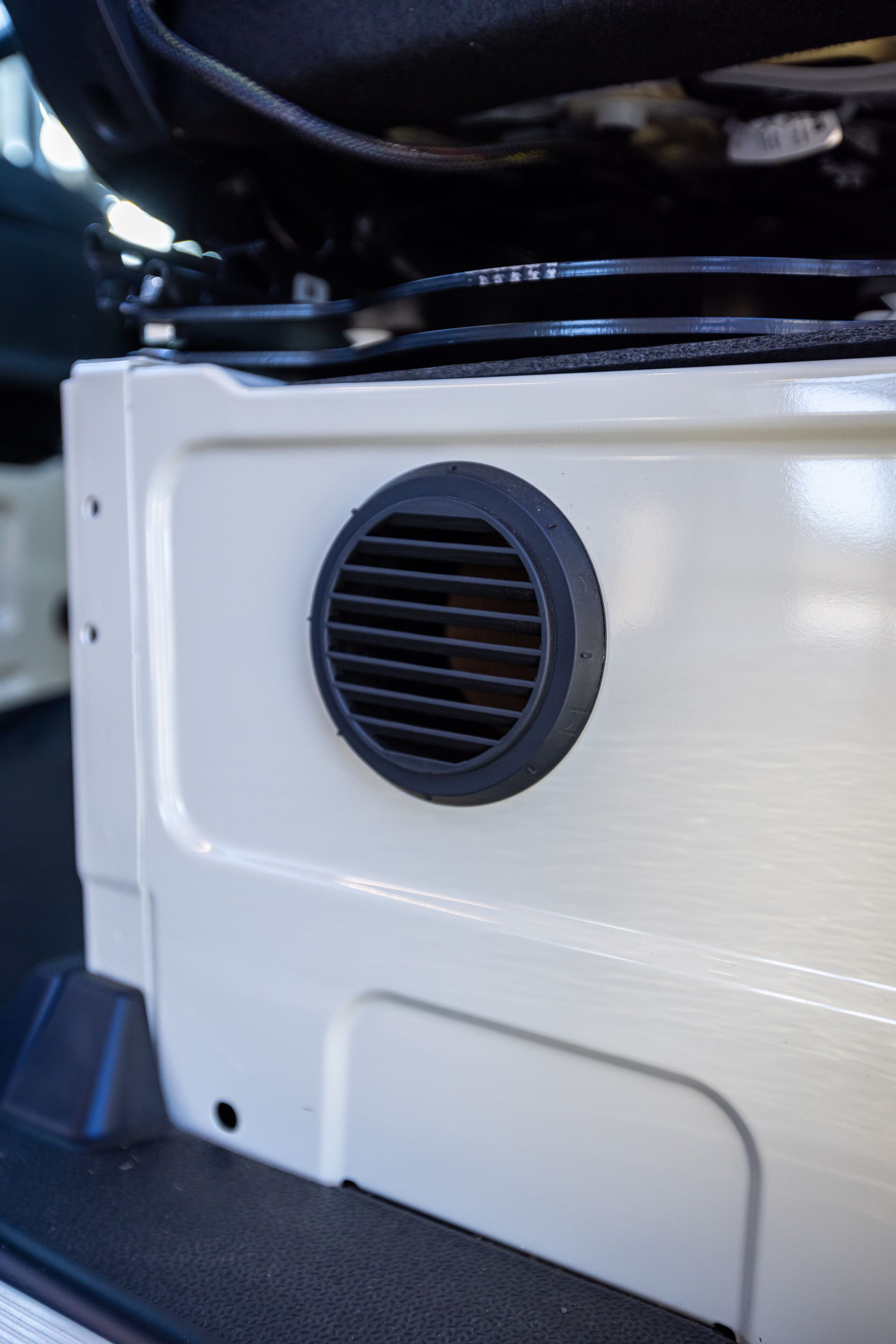 A close up of a vent on the side of a car.