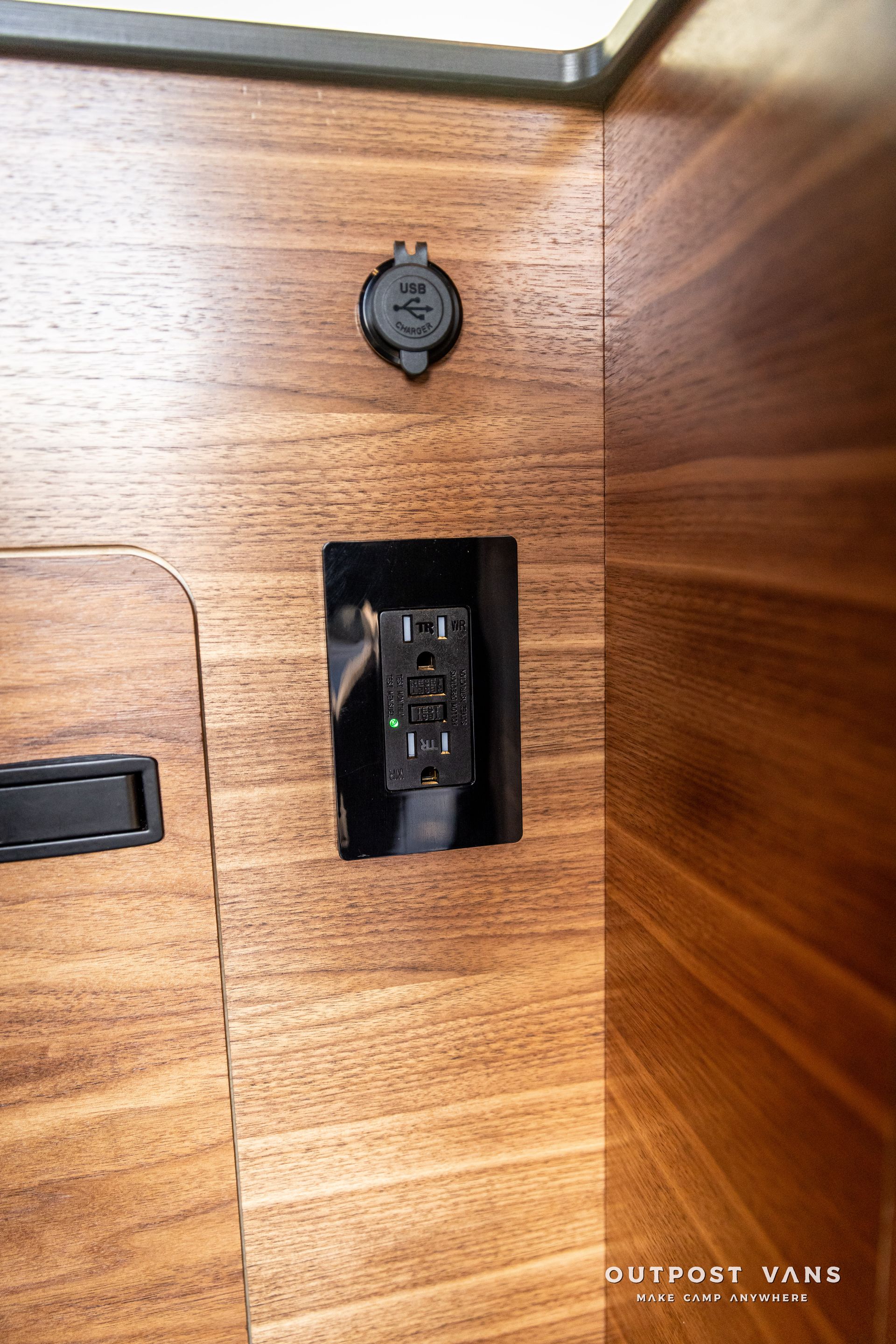 a wooden wall with a electrical outlet on it .