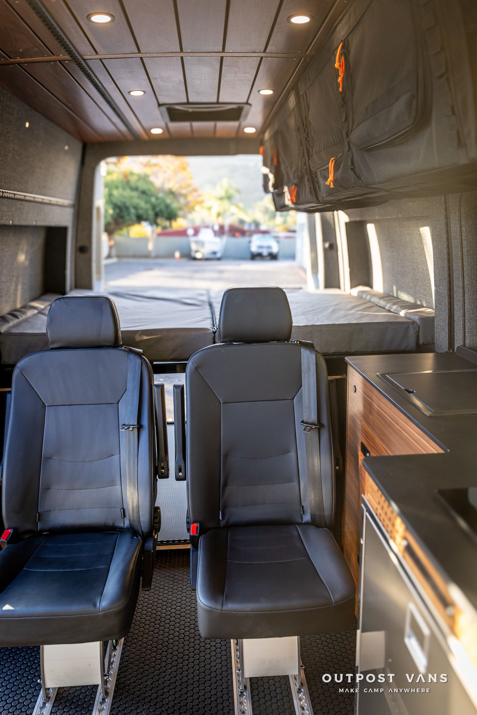 the inside of a van with two seats and a kitchen .
